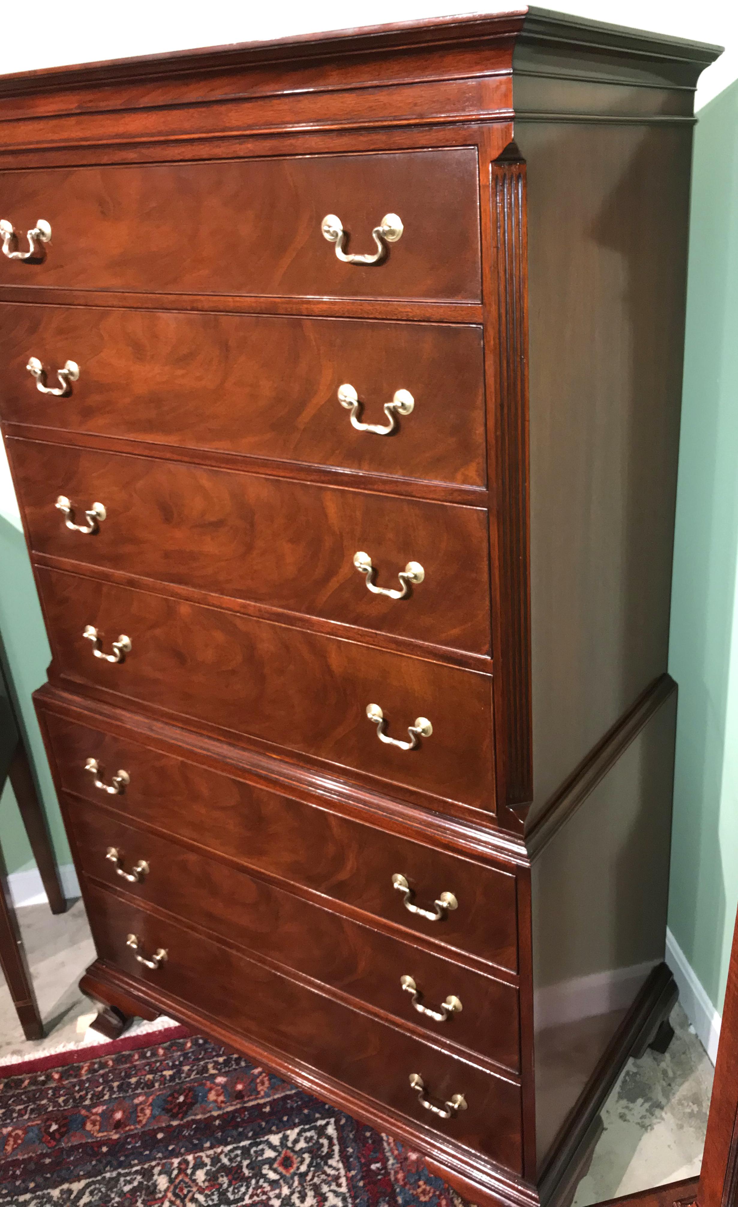 A fine Kaplan Furniture two piece mahogany chest on chest made for the Beacon Hill collection, its upper case featuring a molded cornice surmounting four graduated drawers, and canted reeded corners, over a lower case with three drawers, all