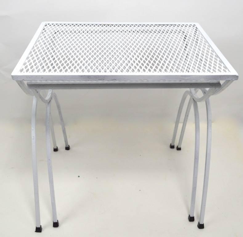 Stylish mesh top wrought iron base nesting tables by Salterini. Suitable for indoor or outdoor use, currently in later white paint finish.