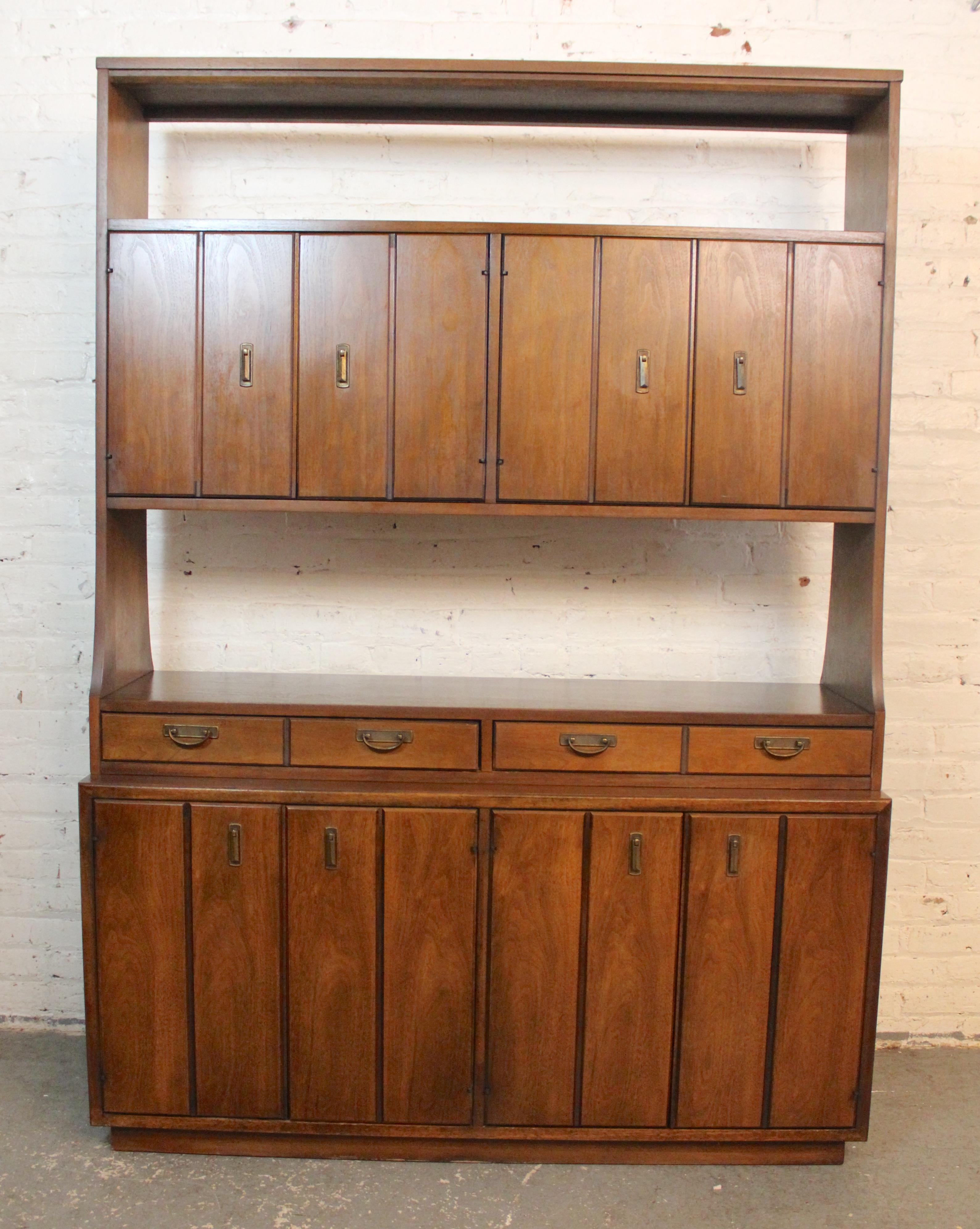 Standing over six feet tall this bookcase is a perfect room divider, featuring a finished back and open storage. Made by Broyhill for their 'Modern Classic' series, this unit has ample storage, including three cabinets, drawers, and open book space.