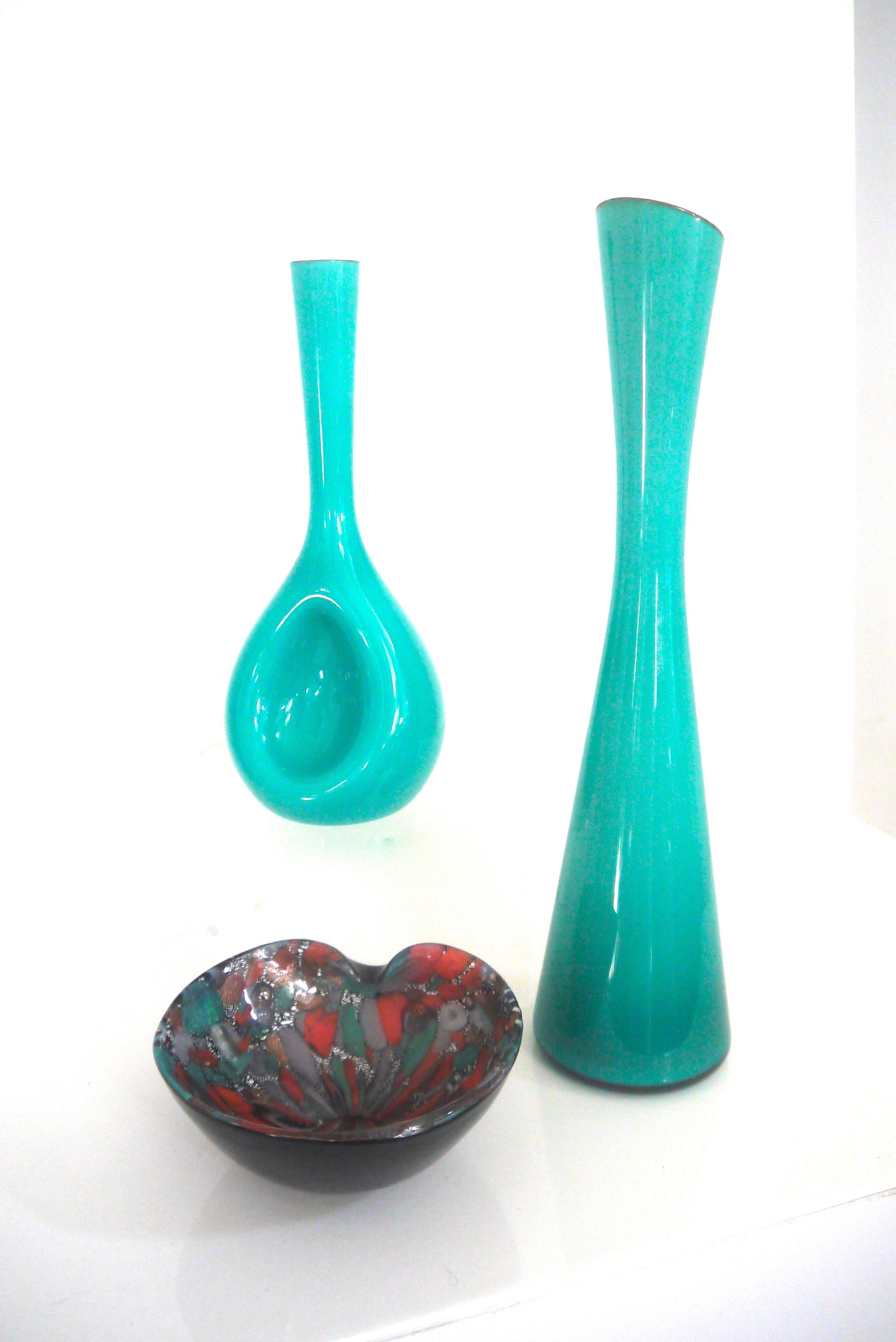 This pair of cased glass vases was designed by Gunnar Ander for Lindshammar in the early 1960s.

The smaller vase measures: Height 25 x diameter 10 cm.
The large vase geight 35 cm diameter 8 cm.

 