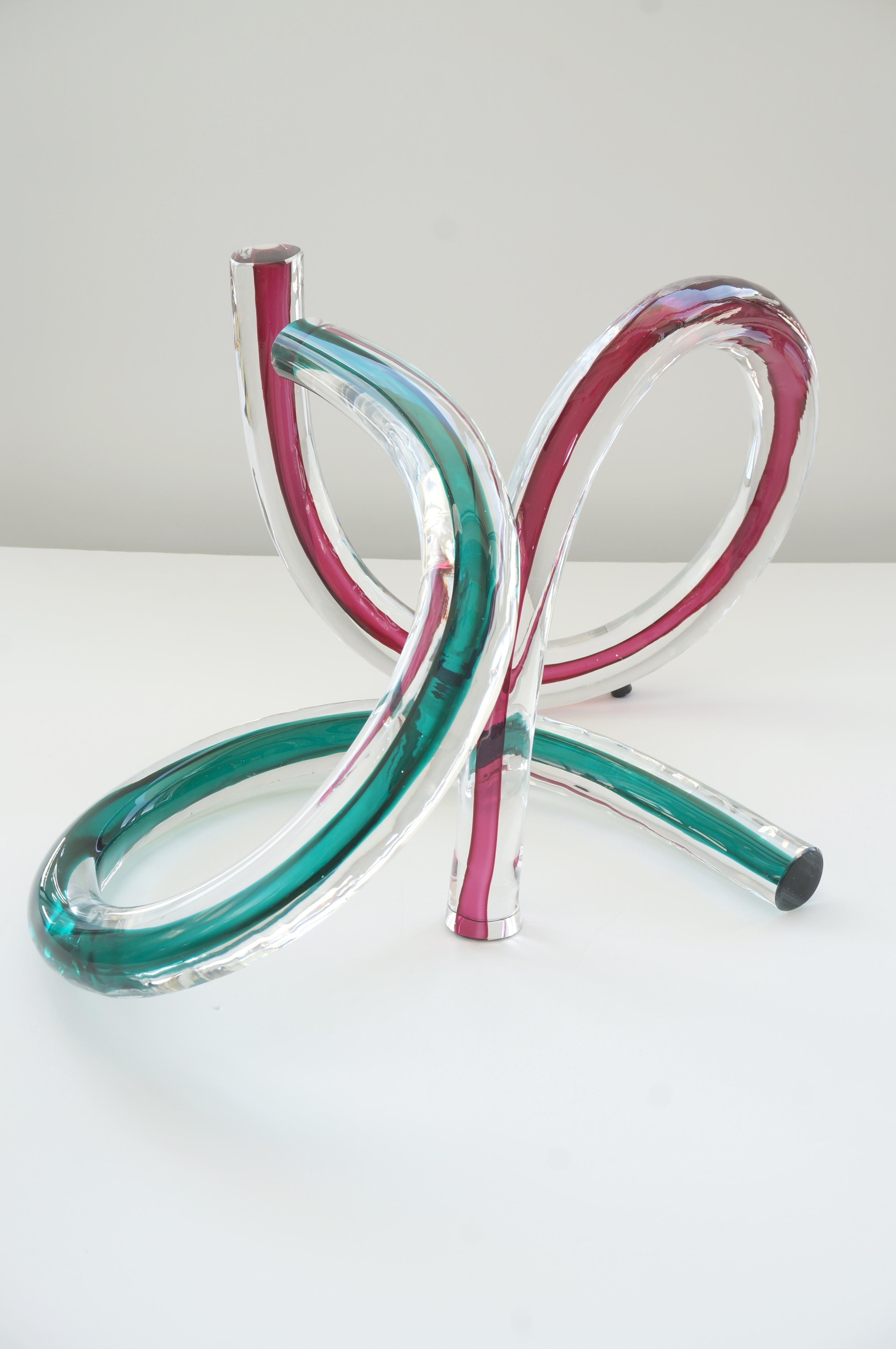 This two piece free-form artisan glass sculptures capture the light beautifully and the pieces can be used independently or in intertwined (see images).

Note: Dimensions of the red and clear are 12.50