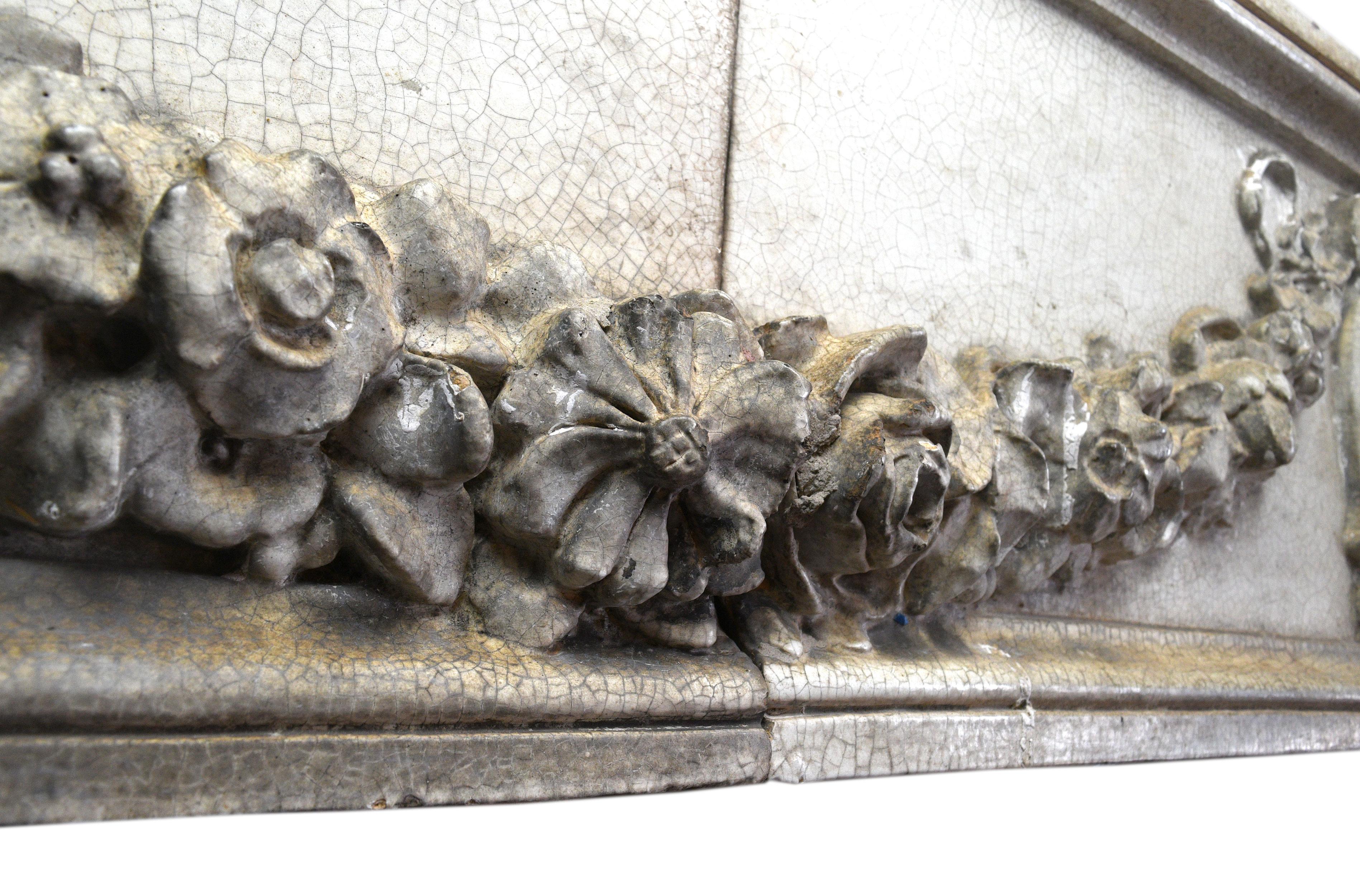 This handsomely carved 2-piece terracotta frieze features a lovely garland design. Sold as a pair.