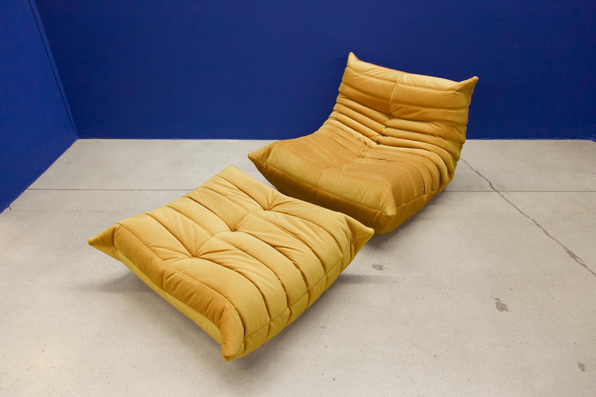 This Togo living room set was designed by Michel Ducaroy in 1973 and manufactured by Ligne Roset in France. It has been reupholstered in golden yellow high quality velvet, and is made up of the following pieces, each with the original Ligne Roset