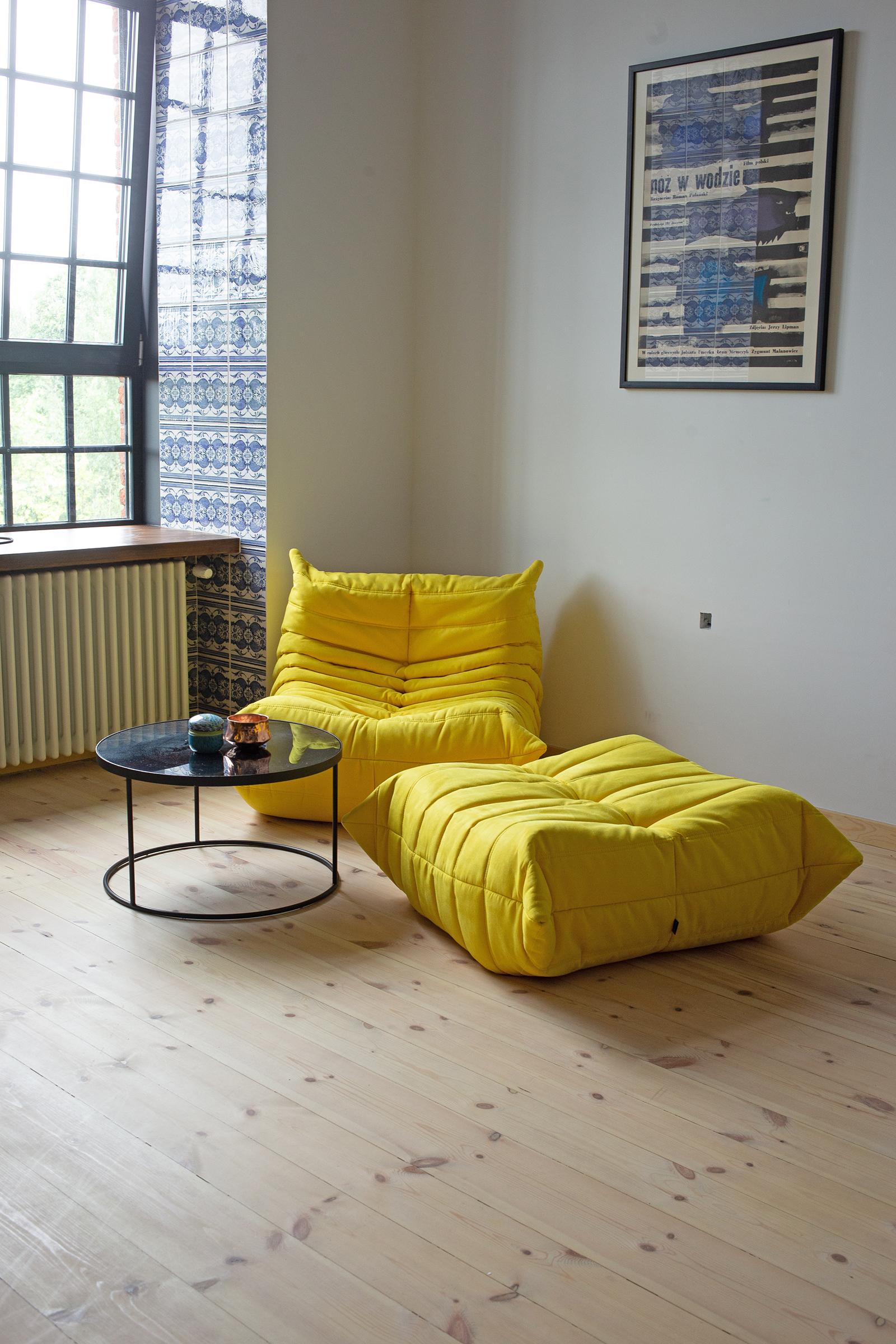 This Togo living room set was designed by Michel Ducaroy in 1973 and manufactured by Ligne Roset in France. It has been reupholstered in yellow high quality microfiber and is made up of the following pieces, each with the original Ligne Roset logo