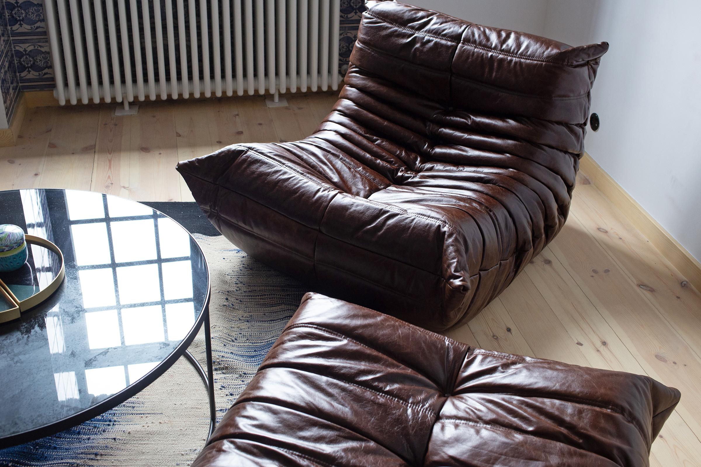 This Togo living room set was designed by Michel Ducaroy in 1973 and manufactured by Ligne Roset in France. It has been reupholstered in Dubai brown high quality leather, and is made up of the following pieces, each with the original Ligne Roset