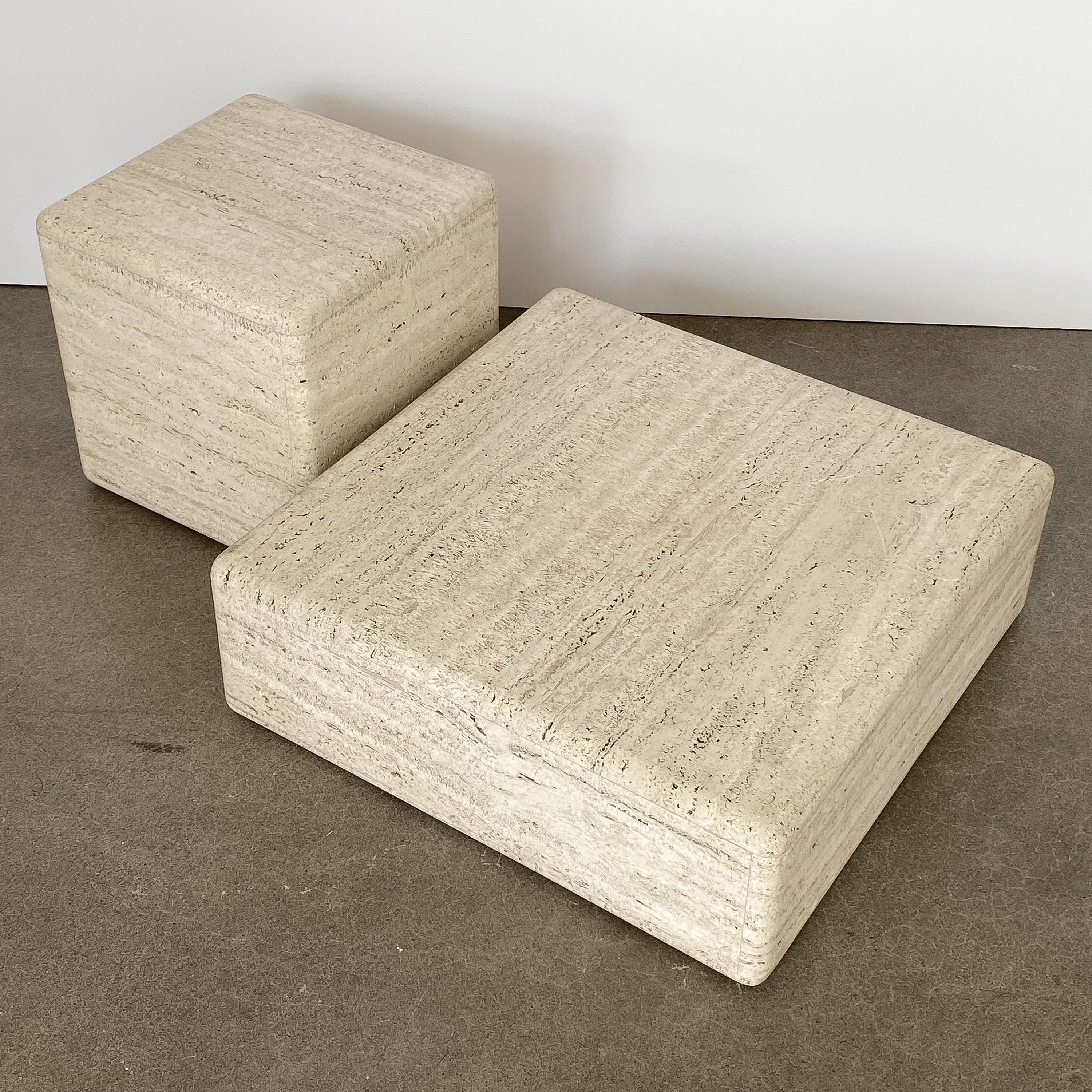Two-piece Italian travertine sculptural coffee table, circa 1960s. A travertine cube and low square slab can be configured together to be used as a tiered coffee table, end table or art display pedestal. Modern Minimalist design. Each piece is