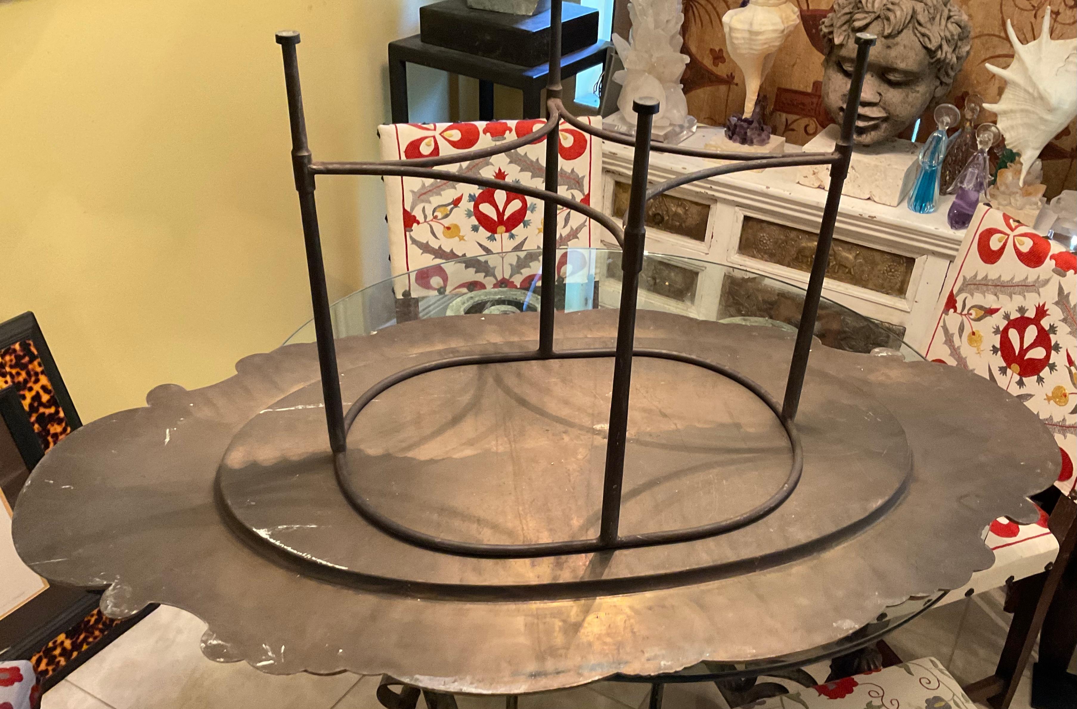 Elegant one of a kind coffee table made of two pieces, hand forged solid iron base marked Made in Italy, and a beautiful brass and copper large table top to set on it.
The two piece are not attached to each other so you have options to use it in