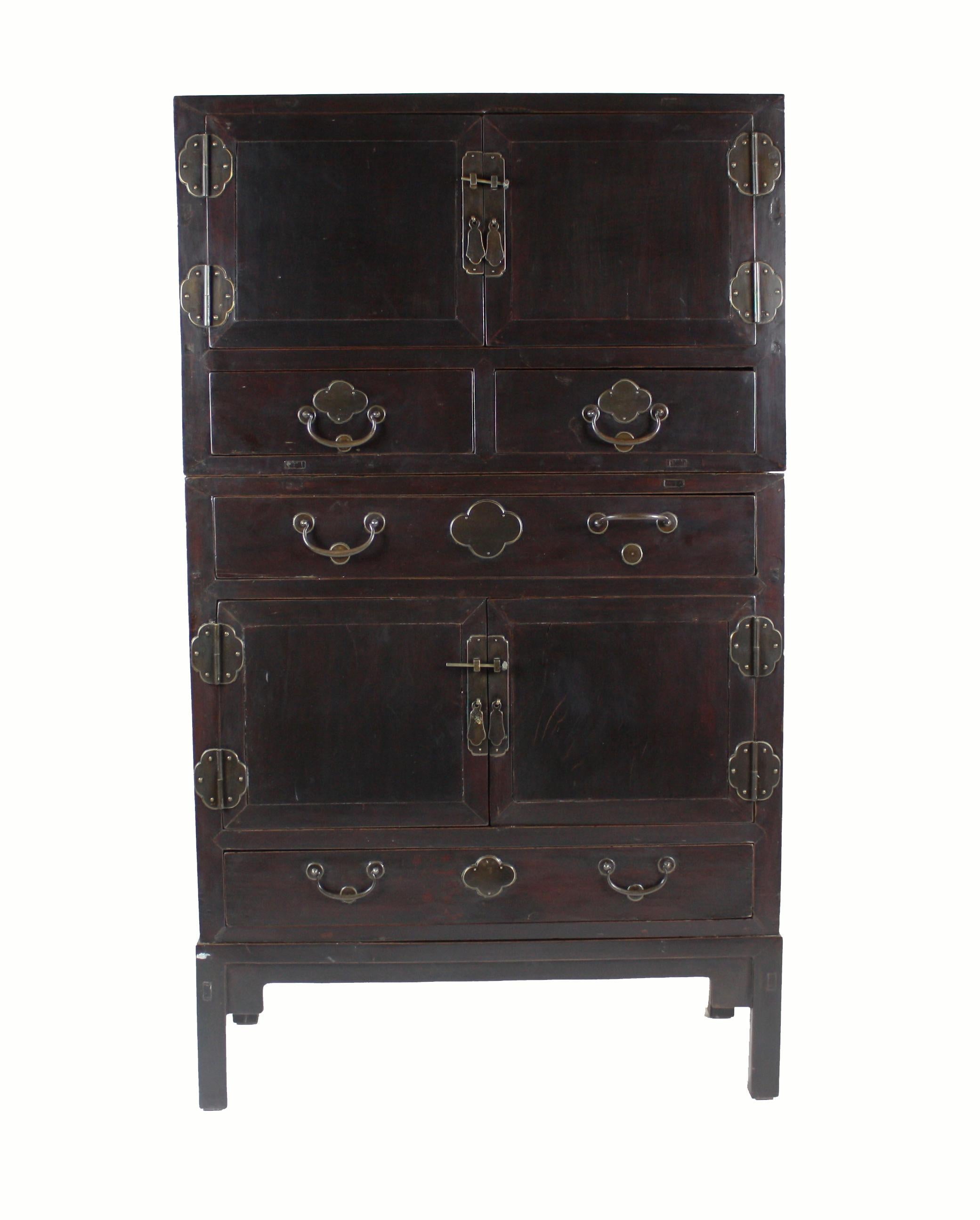 This antique Chinese cabinet consists of two separate cabinets and one stand that can be modified to fit space restrictions. Use it as one tall cabinet or two smaller cabinets, without the stand, or one cabinet with stand. The top cabinet has one