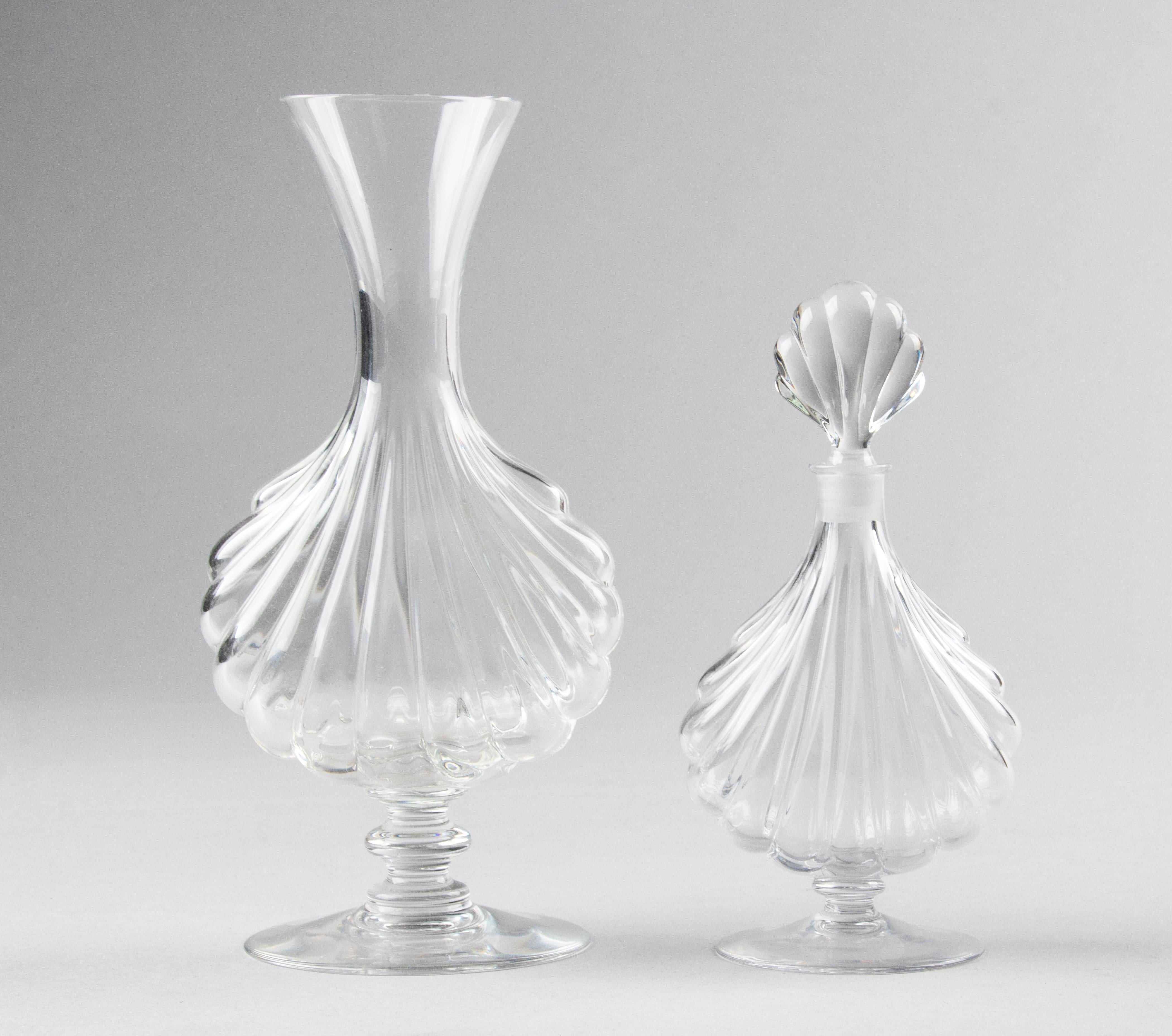 Small crystal bottle and crystal vase made by the French brand Baccarat, from the series Primevere. 
The bottle is 17 cm tall and the vase is 21 cm tall. 
Both in good condition and marked on the bottom.
 
