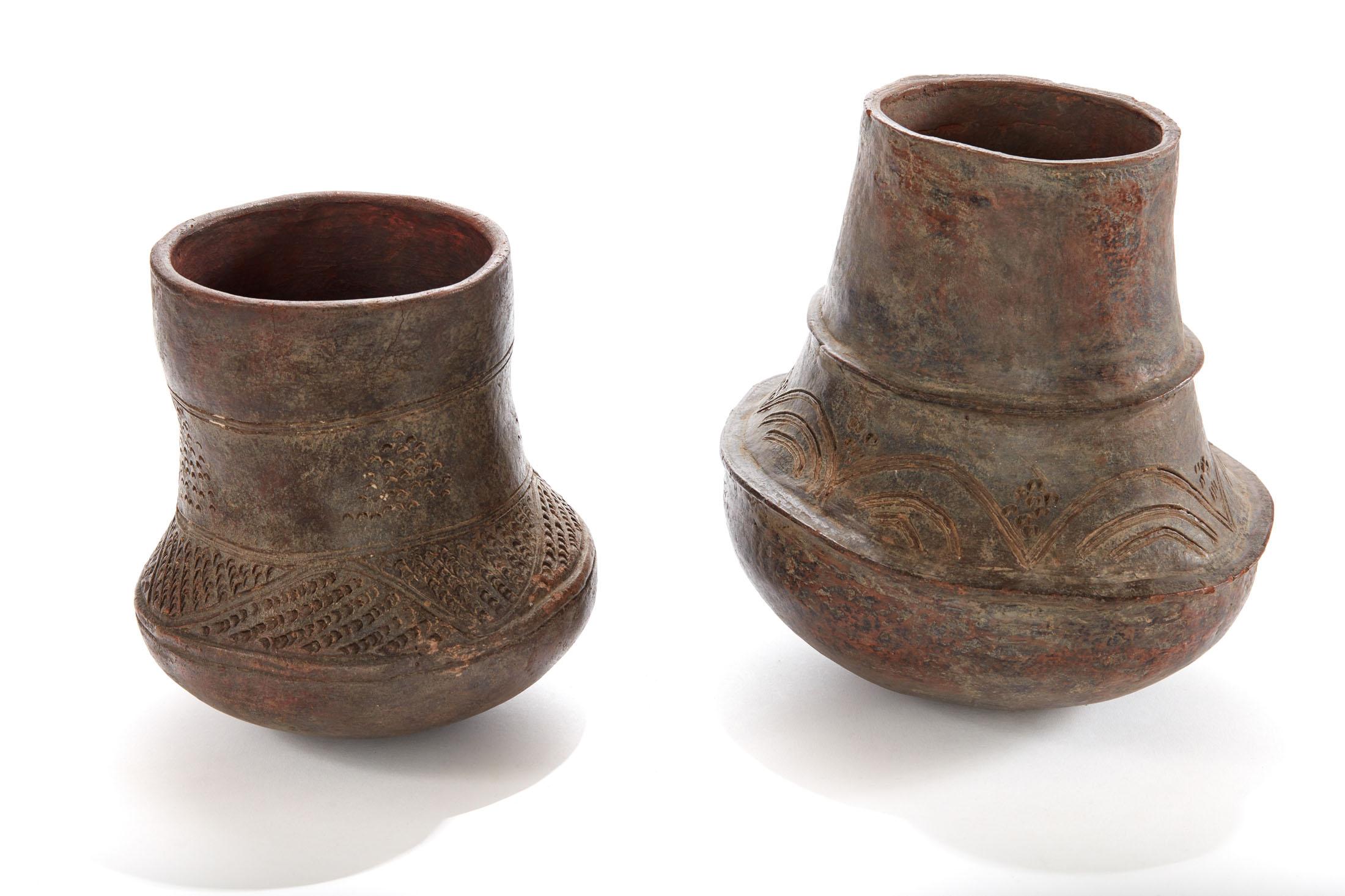 Two pieces of a pair of early 20th century etched African Vessels from Mali
The patina is gorgeous on this pair of storage vessels from Mali. Classic patterned etchings
Sold separately. 

Dimensions:
Larger vessel is 10.5 in. H and has a 10 in.