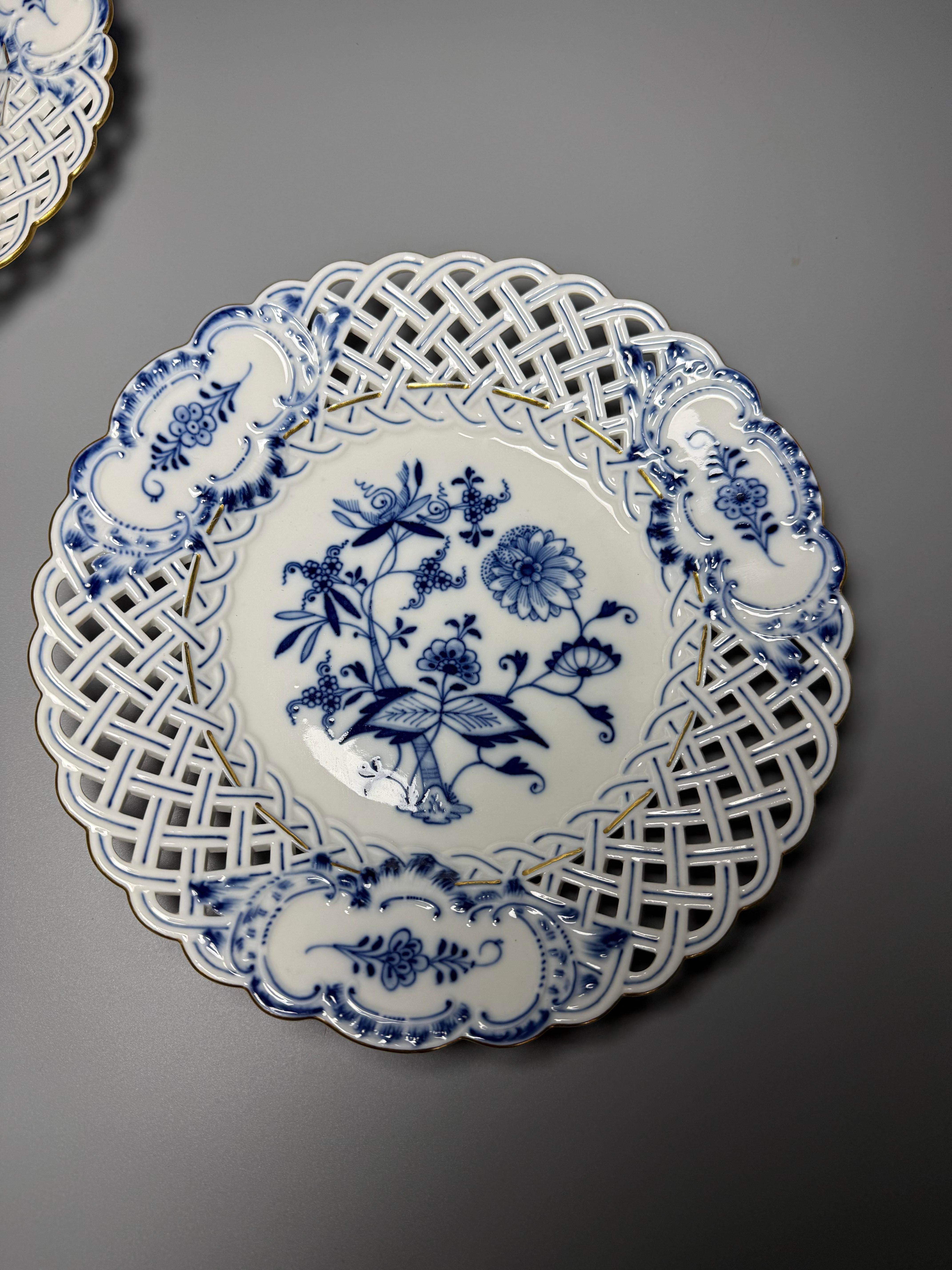 Meissen Blue Onion Pierced 2 Luncheon Plates 
Design: Features the classic Blue Onion (Zwiebelmuster) pattern with stylized floral and fruit motifs, including peaches and pomegranates, inspired by East Asian porcelain. 
Features: Notable for its