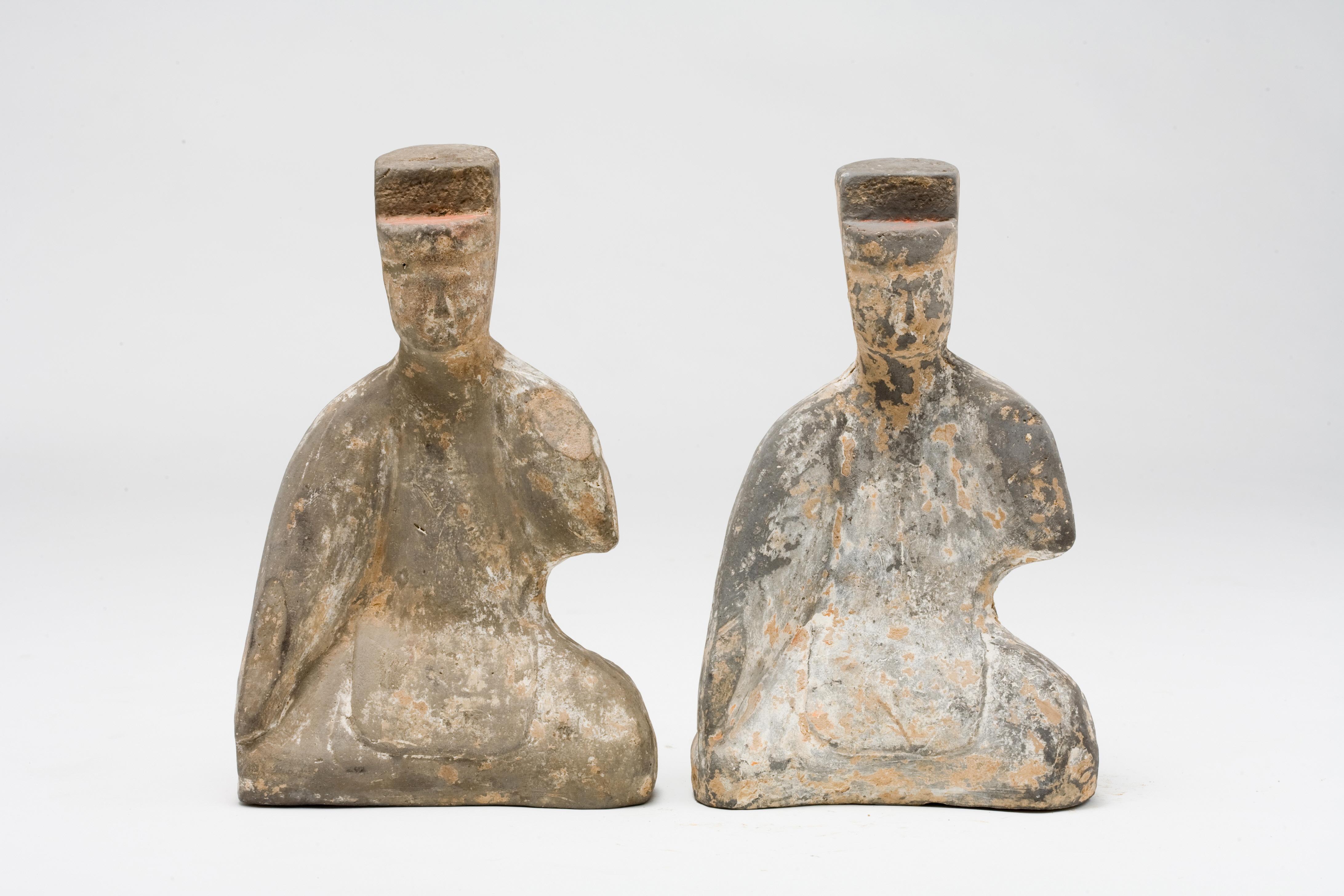 The statuette shows traces of the original red, black, and white pigmentation. Ceramic statuette from the han Dynasty, depicting two court people, probably a musician. They are dressed in a long dress with wide sleeves and wears a traditional