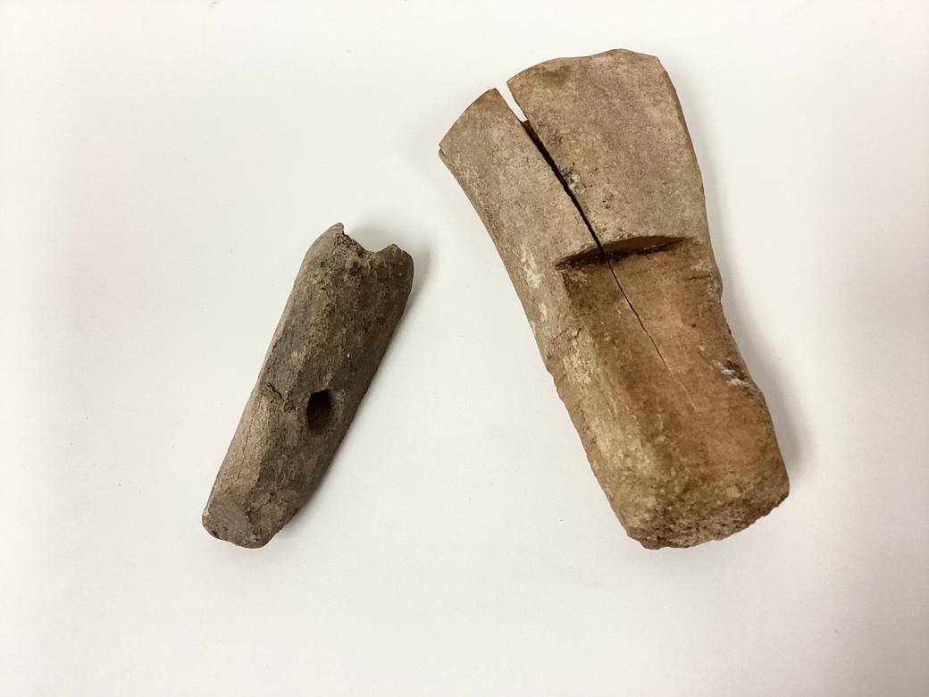 Two carved bone tool Handles from the Pre-Inuit Thule Culture in all original condition. Probable wood working tools, the handles once held Stone or, more rarely, Iron blades. The larger handle with top cut section to receive the wooden handle and
