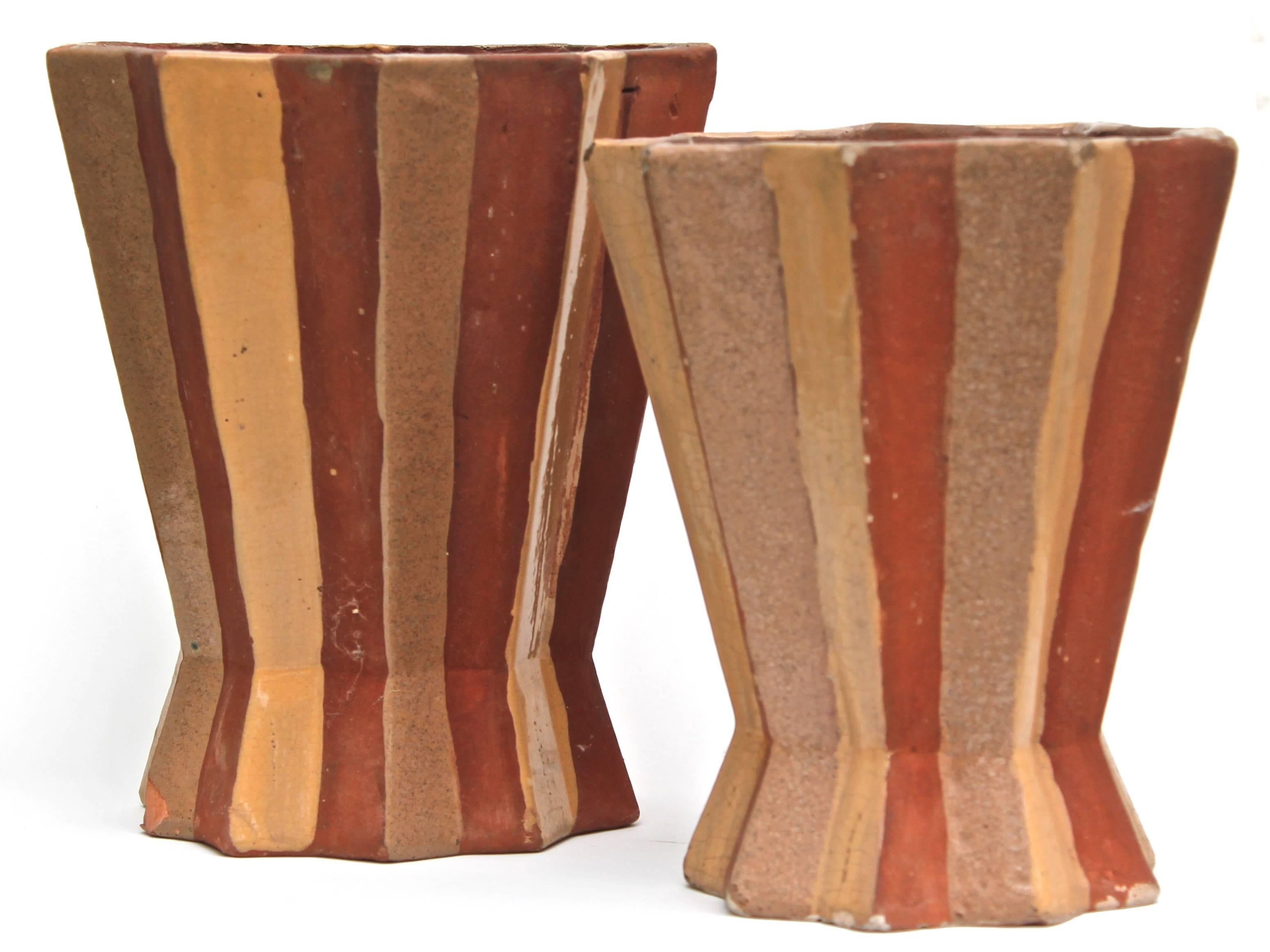 Two primavera vases in terra cotta designed and signed by Madeleine Souges. The larger: 9 1/4