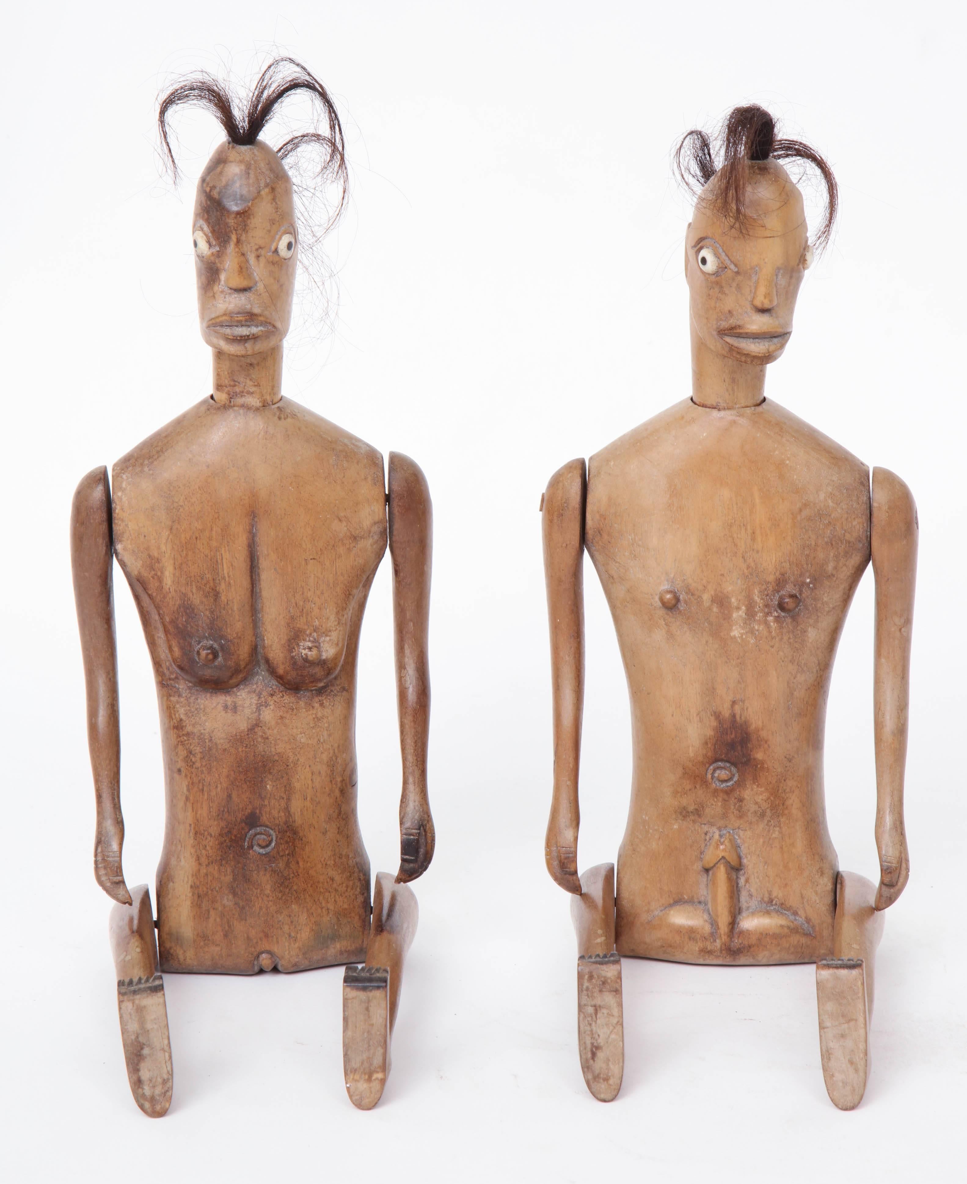 Two articulating Indonesian figures from Lumbock, near Bali, early 20th century, man and woman. Arms, legs and head move. Carved wood, paint and animal hair.