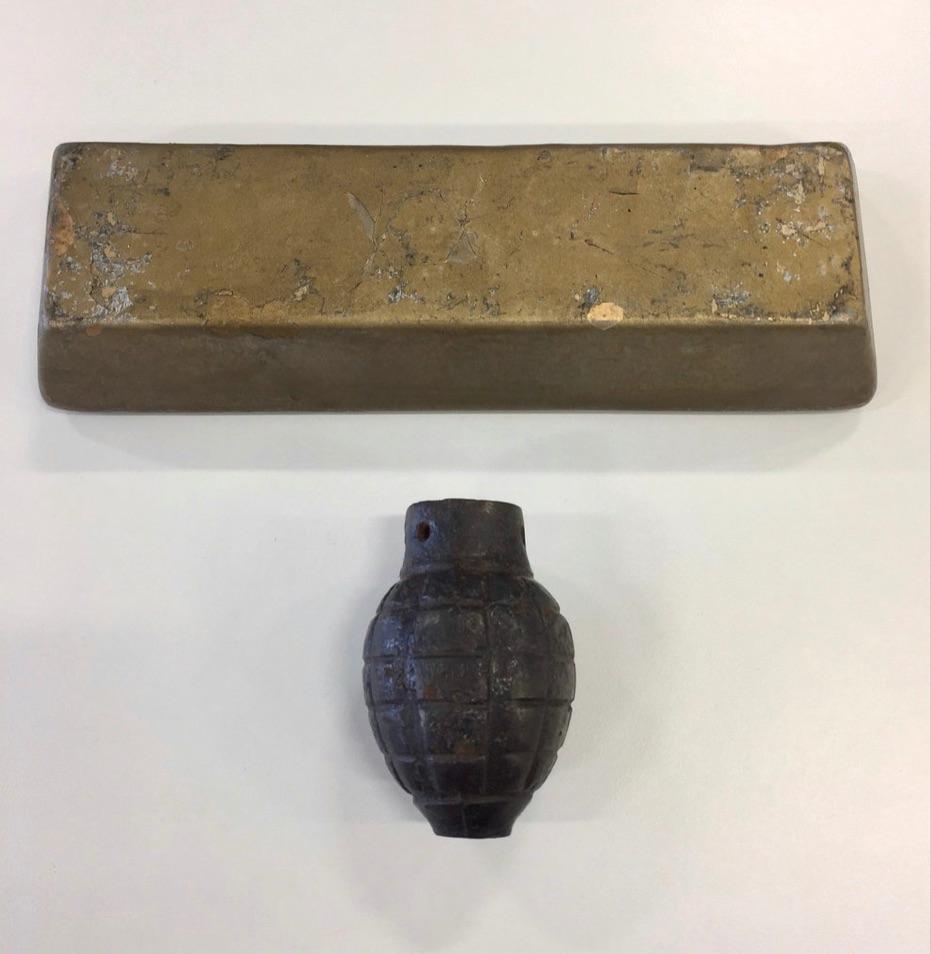 A prop hand grenade and gold bar from Classic Bond movie Goldfinger (1964). 

Goldfinger is the third film in the James ond franchise and is among the highest regarded, introducing many of the key elements that would define the series. It’s one of