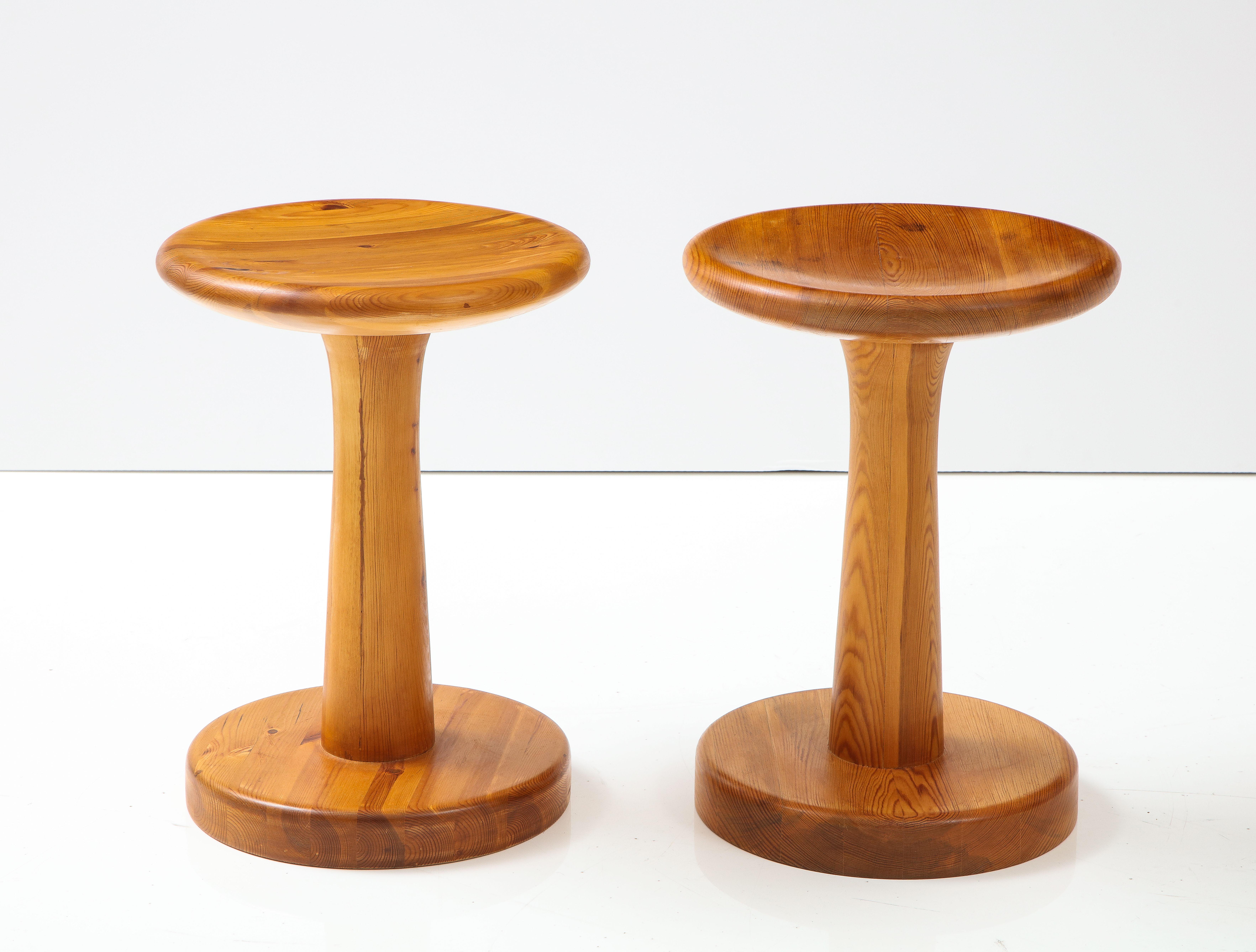 Two pine stools or side tables designed by Rainer Daumiller and produced by Hirtshals Savvæk, Denmark, Circa 1970, with thick solid circular tops raised on pedestal stem with a circular base. They are good as both stools or side tables.


