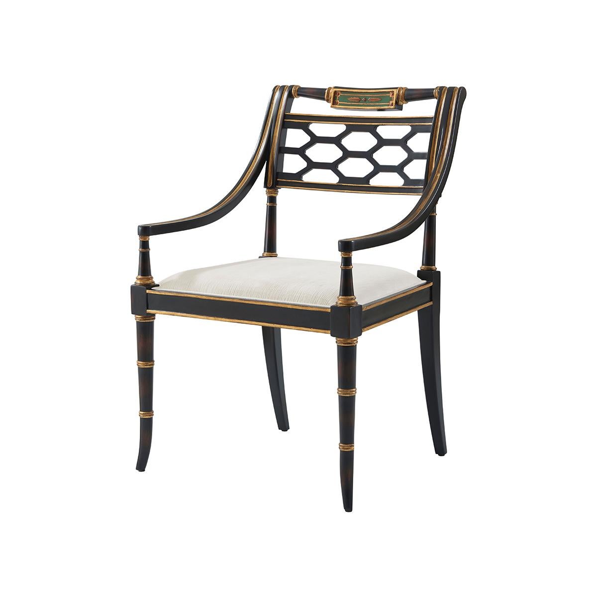 Classic English style ebonized and parcel-gilt occasional chair, the reeded, turned and bar top rail above a pierced trellis back, the upholstered drop-in seat between down swept channeled arms, on splayed ring turned legs. 
Dimensions: 25