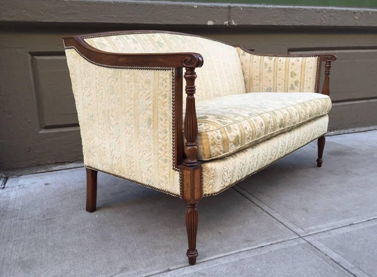 Two Regency style sofas with walnut frame. Carved fluted legs, original fabric and a loose cushioned seat.

 