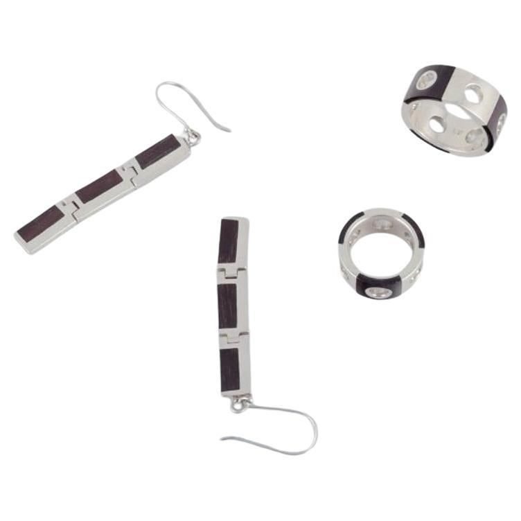 Two rings and a pair of earrings in sterling silver and dark wood. 1980s