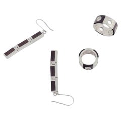 Two rings and a pair of earrings in sterling silver and dark wood. 1980s