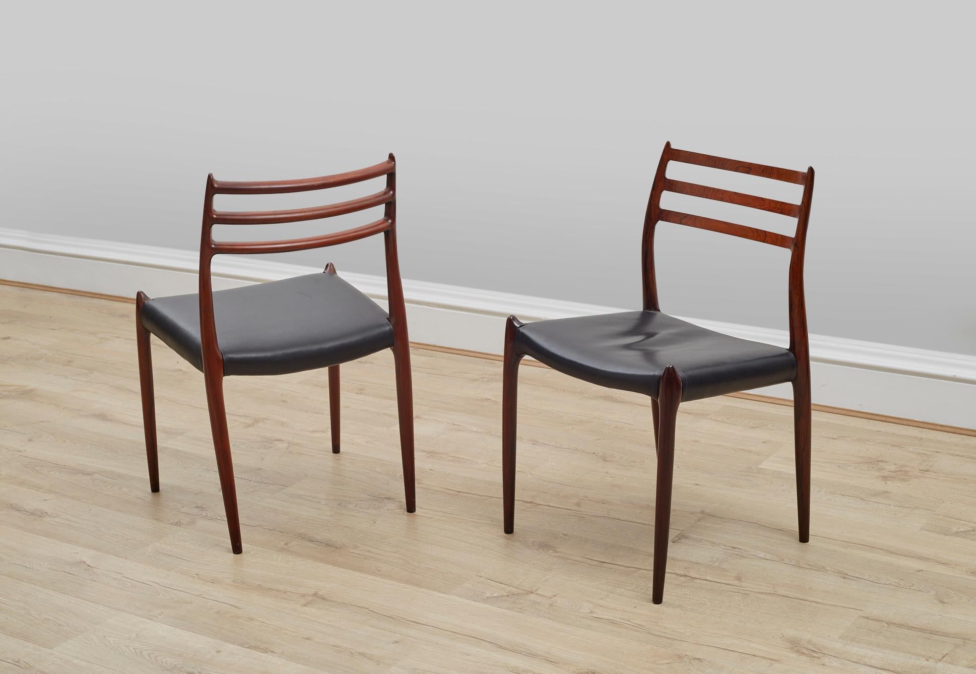 A set of two rosewood side chairs designed by Niels Otto Møller in 1962, each chair is stamped underneath, the chairs are in excellent condition throughout and have had new black leather upholstered seats.

