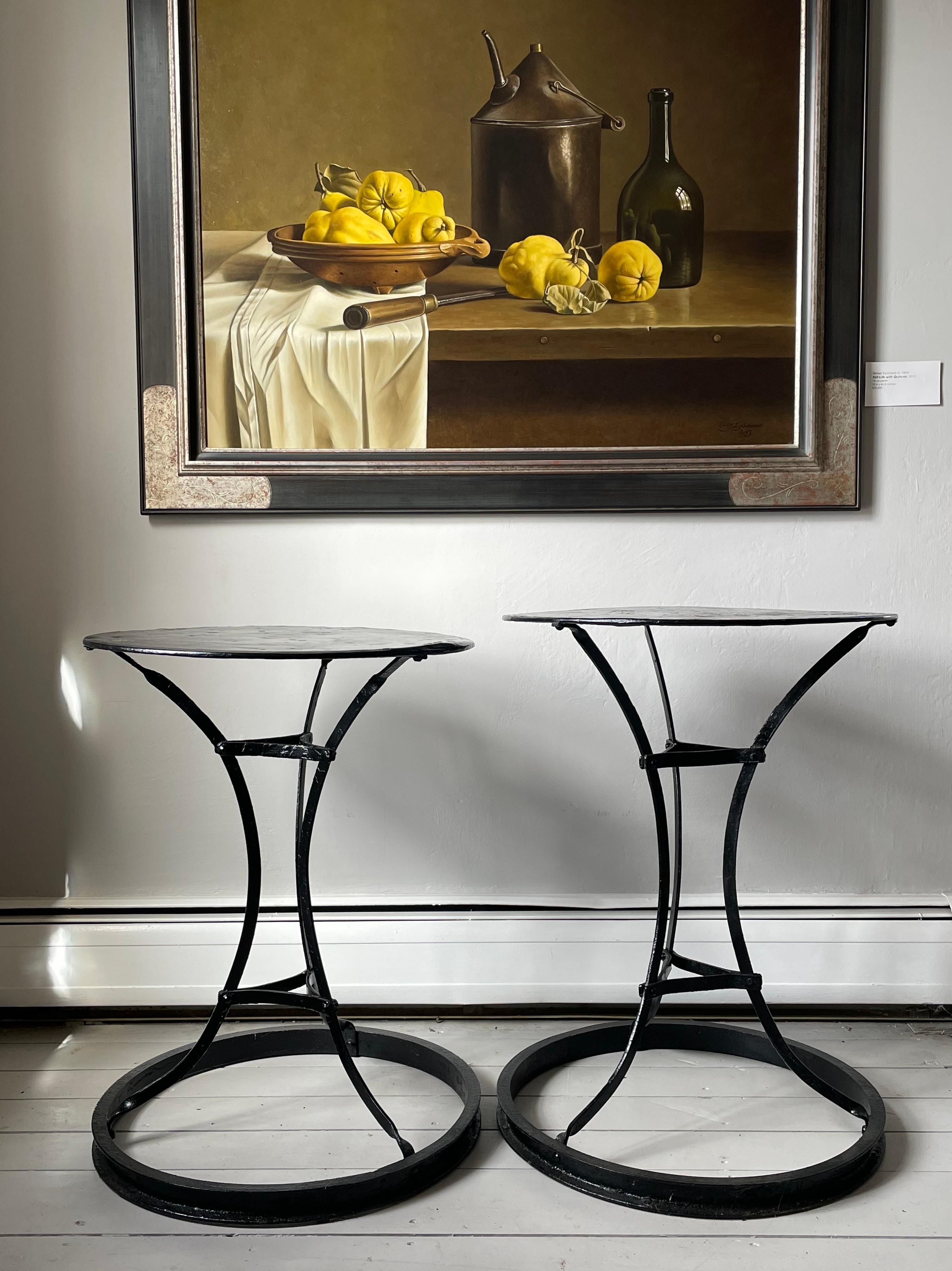 We love the open form of these café or bistro tables, particularly since the sweeping legs are so graceful and the round bases make them extra-stable. In newer glossy black paint, they are in lovely condition (albeit with the usual little dents to