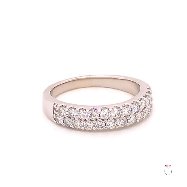 Stunnung two row diamond band ring in 14K white gold. This beautiful Diamond band feartures 24 round brilliant cut diamonds set in shared prongs. The diamonds are set in two rows of twelve diamonds going half way around the band. The diamonds are