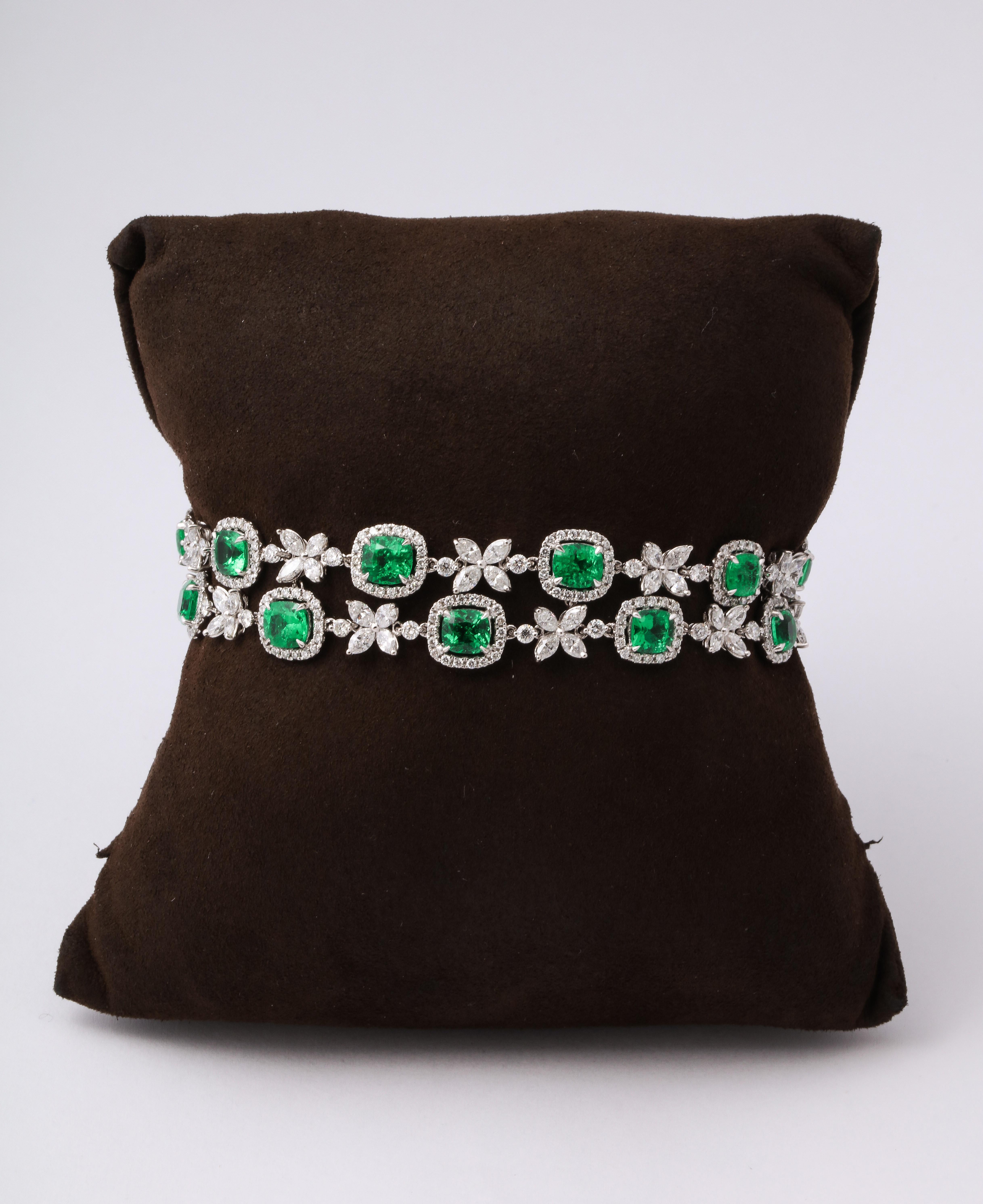 An elegant bracelet with a pop of color. 

9.37 carats of fine quality cushion cut emeralds.

6.72 carats of white marquise and round diamonds. 

18k white gold 

6.75 inch length, half an inch wide. 