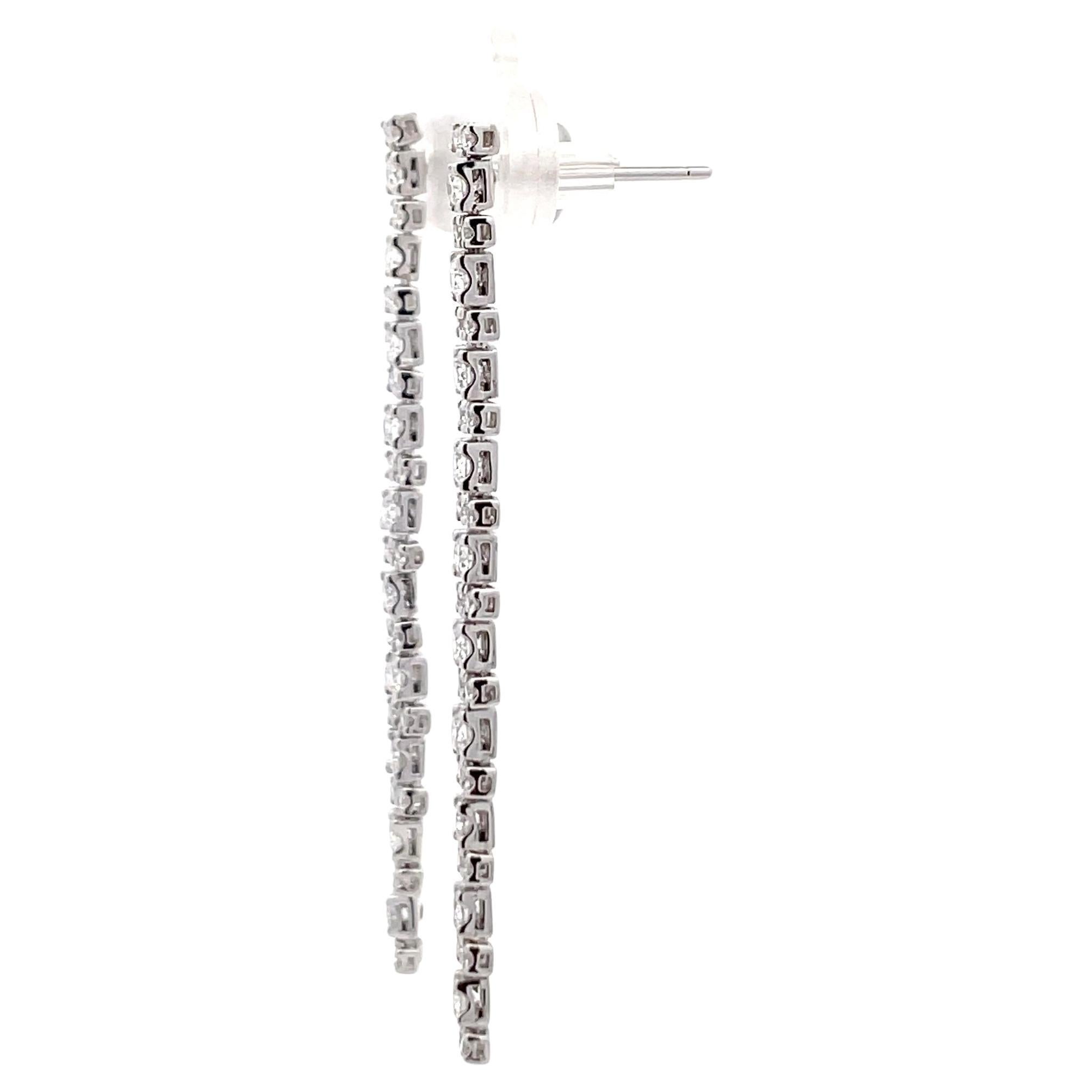 18 Karat white gold dangle drop earrings featuring two rows of 64 round brilliant weighing 1.05 carats.
Color G
Clarity SI