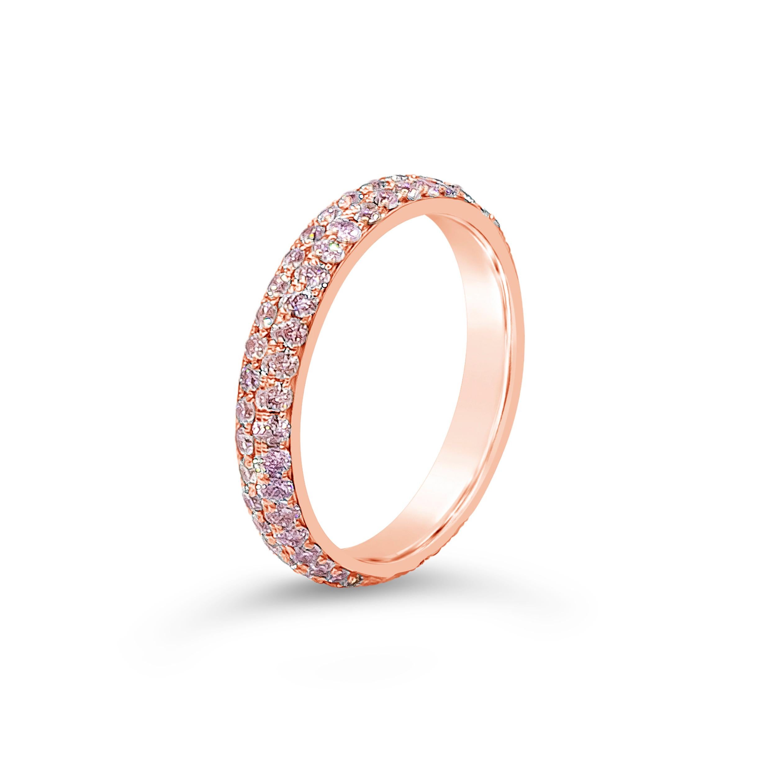 A gorgeous and chic rose gold wedding band showcasing two rows of round pink diamonds, micro-pave set in a rounded 18 karat rose gold mounting. Pink diamonds weigh 1.11 carats total. A versatile piece that can be used as a fashion ring. Size 6.5