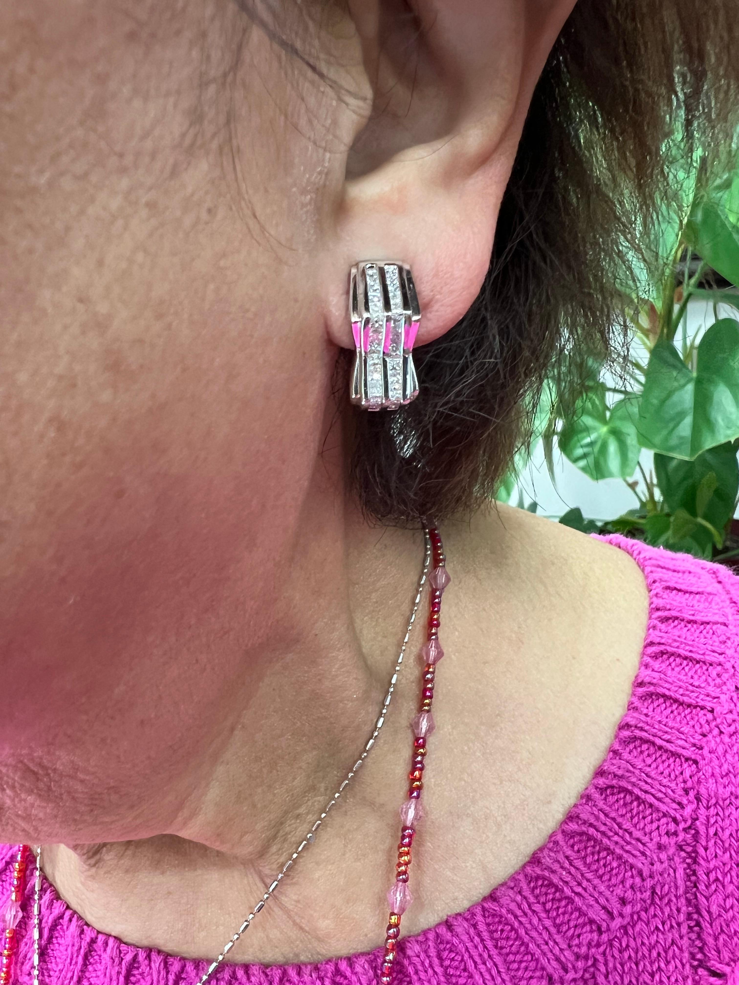 Two-row channel set princess cut diamond white gold earrings, circa 2000.

The two-row channel set princess cut diamond white gold earrings are geometrically designed hoops with a focus on Art Deco. The earrings have omega clips and