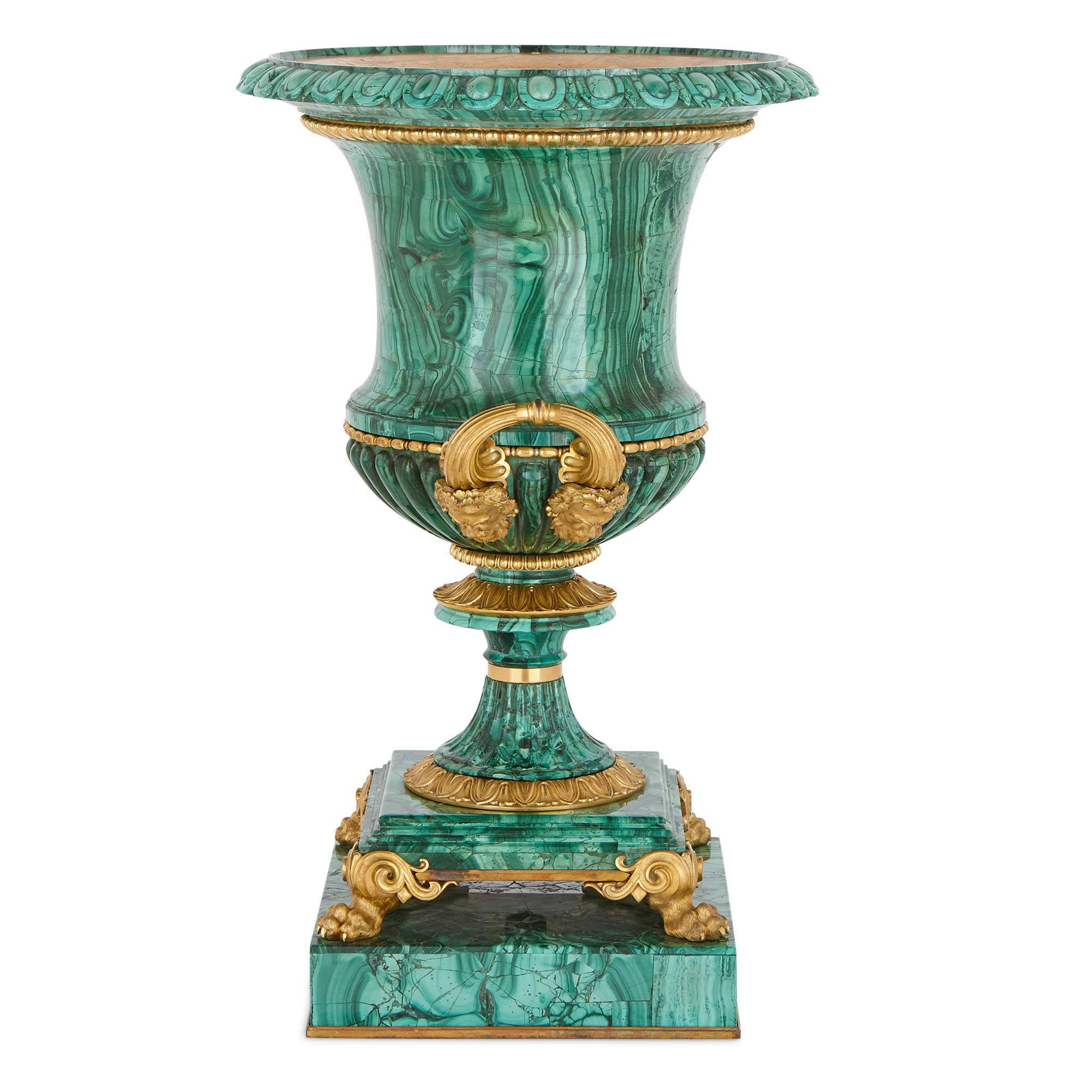 These magnificent gilt bronze (ormolu) mounted malachite urns were created in c.1830 to a design by Ivan Ivanovich Galberg (Russian, 1782-1863). Galberg was an important figure, who served as the architect of the Imperial Russian court from 1817,