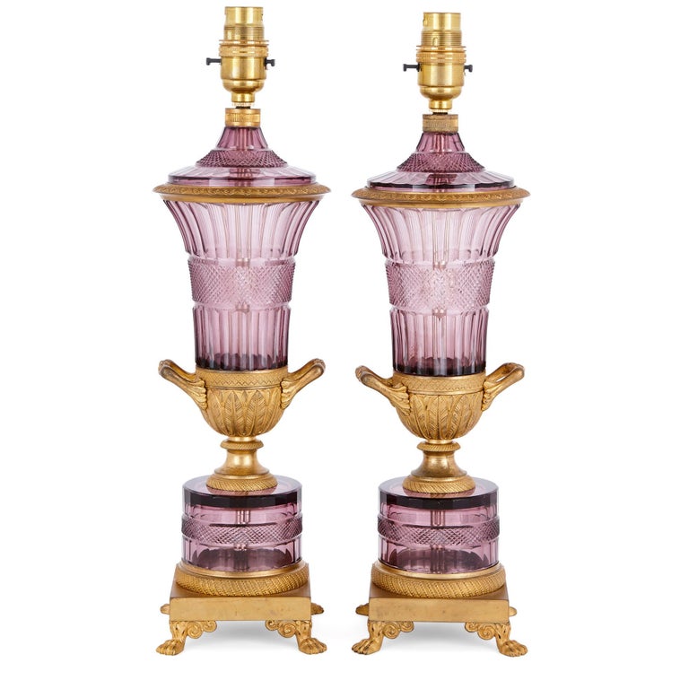 These lamps are truly exceptional antique pieces of Russian design. They were created in the 19th century, in the refined neoclassical style which was in fashion at the time. They are crafted from Fine purple amethyst crystal glass and gilt bronze