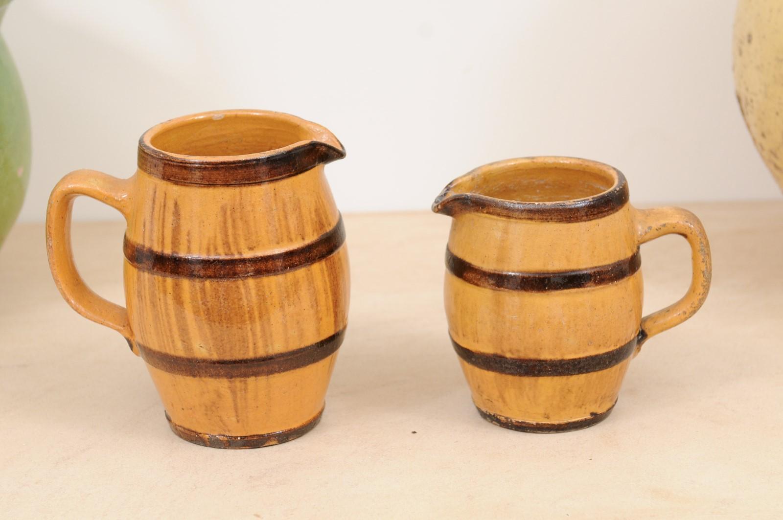 Glazed Two Rustic French 19th Century Pottery Pitchers with Yellow and Brown Glaze For Sale