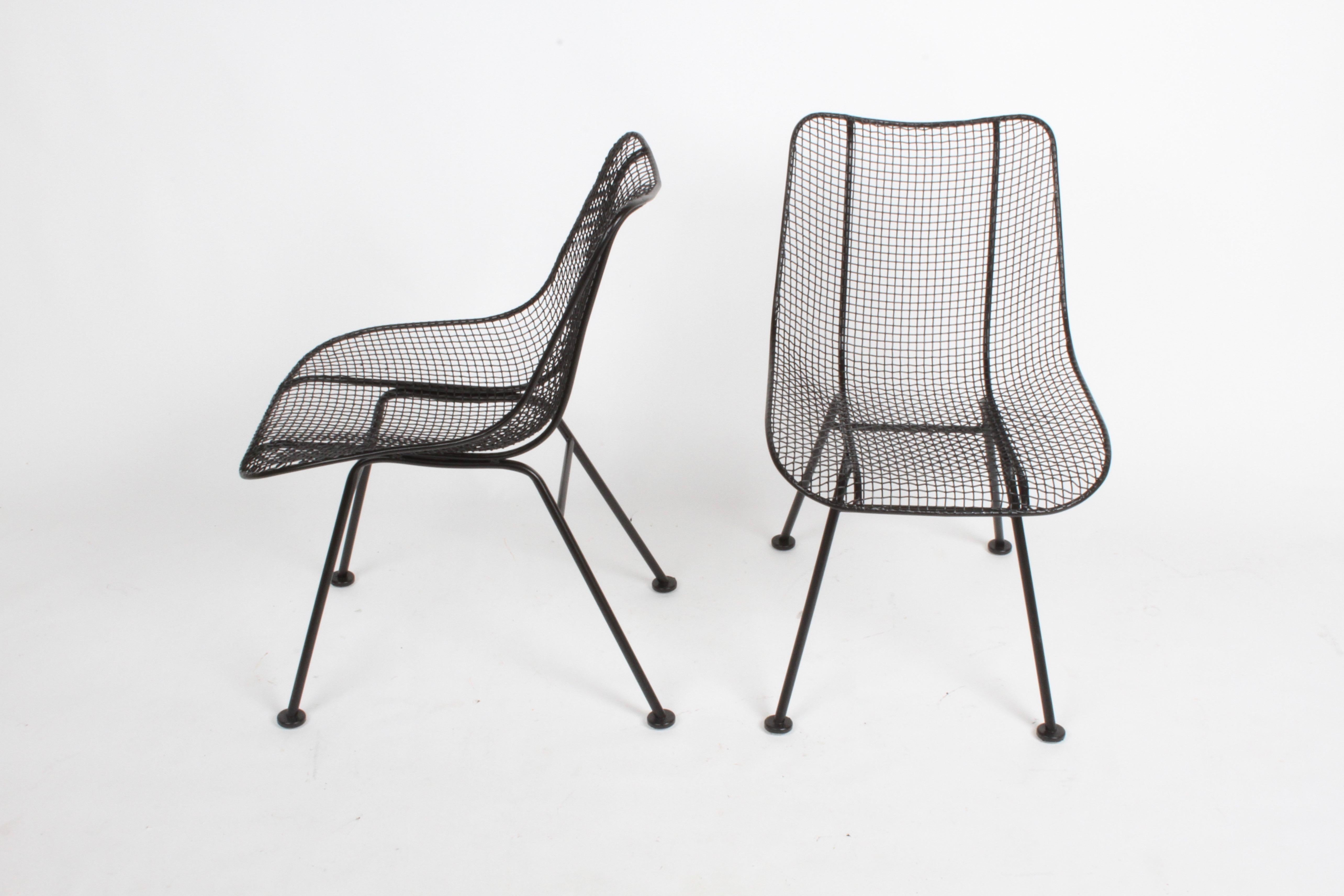 Satin black Woodard sculptura mesh dining chairs, restored condition. Each chairs have been sand blasted, dipped in rust inhibitor primer and painted in satin black. New glides to bottoms of chairs. Listed as single chairs.