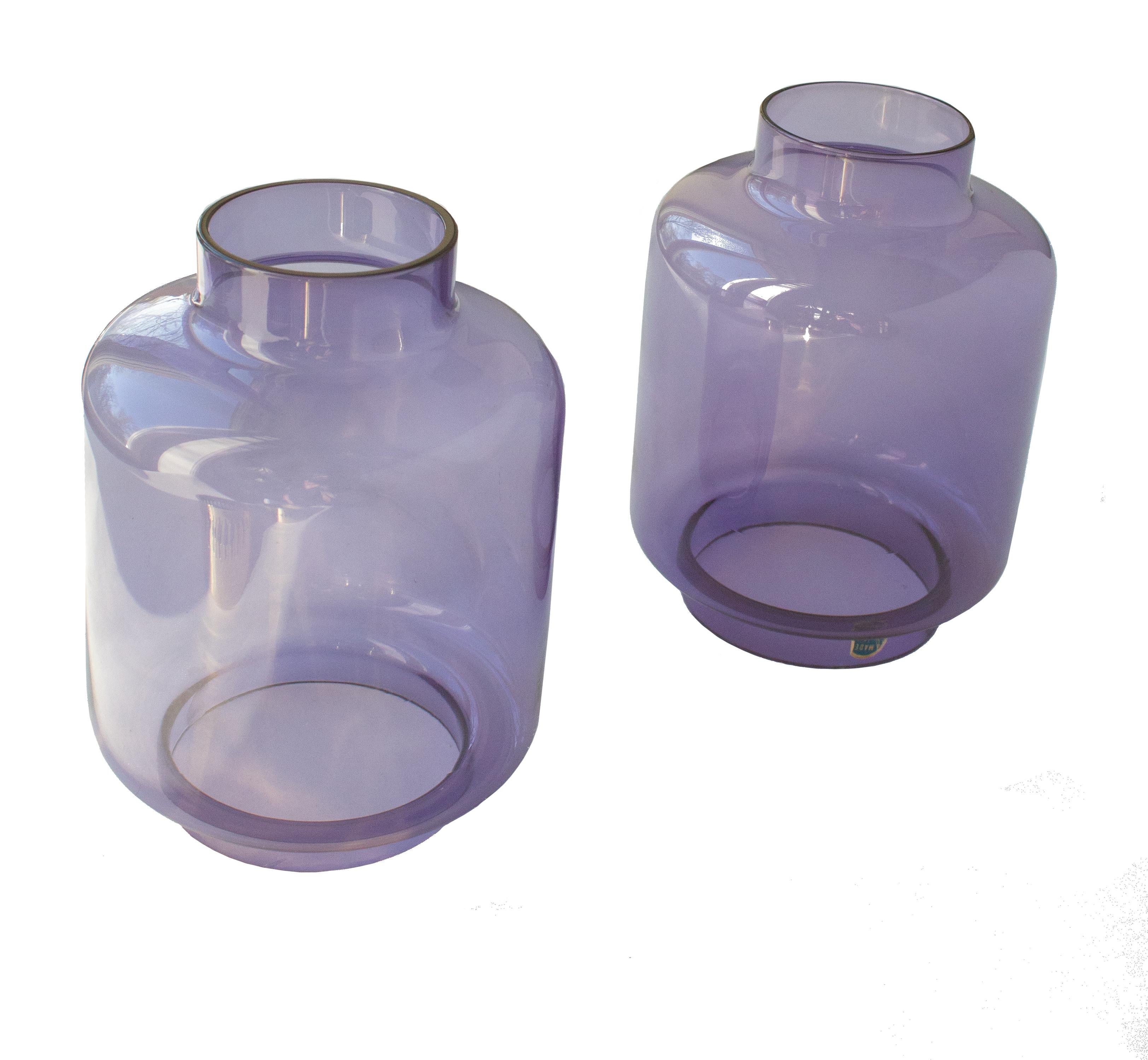 A set of three hurricane candleholders crafted from brass and unusual lilac glass, designed and produced by Hans-Agne Jakobsson AB in Markaryd, Sweden, during the 1960s. These timeless pieces are in excellent condition and showcase Jakobsson’s