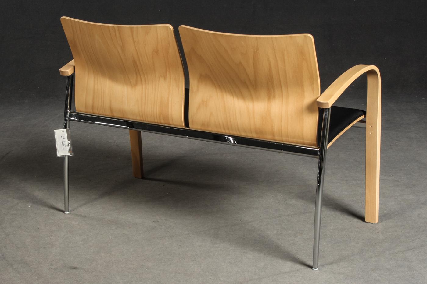 Two-seat bench by Brunner Zweisitzer. Frame steel and plywood. Seat shell molded beech plywood. Upholstered seat, fabric cover in black. Wooden parts natural lacquered. Wooden parts slightly bumped, slight scratching.