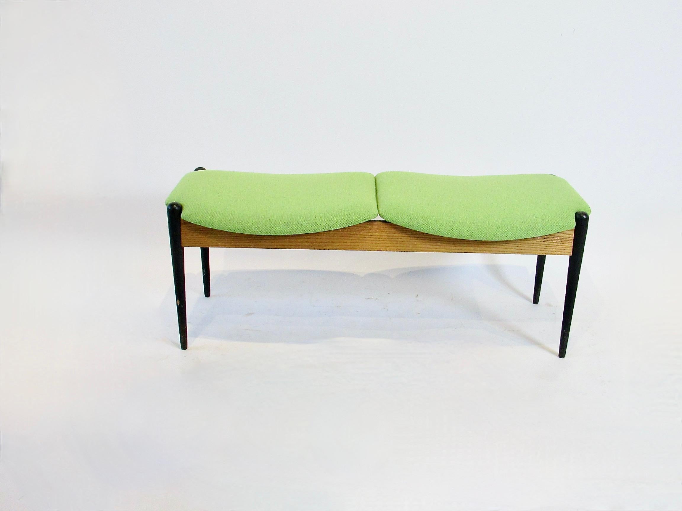 Two seat modernist entryway or front of bed bench . Designed by Arthur Umanoff for Washington woodcraft . Ash frame with ebonized legs supports recently upholstered seats . 