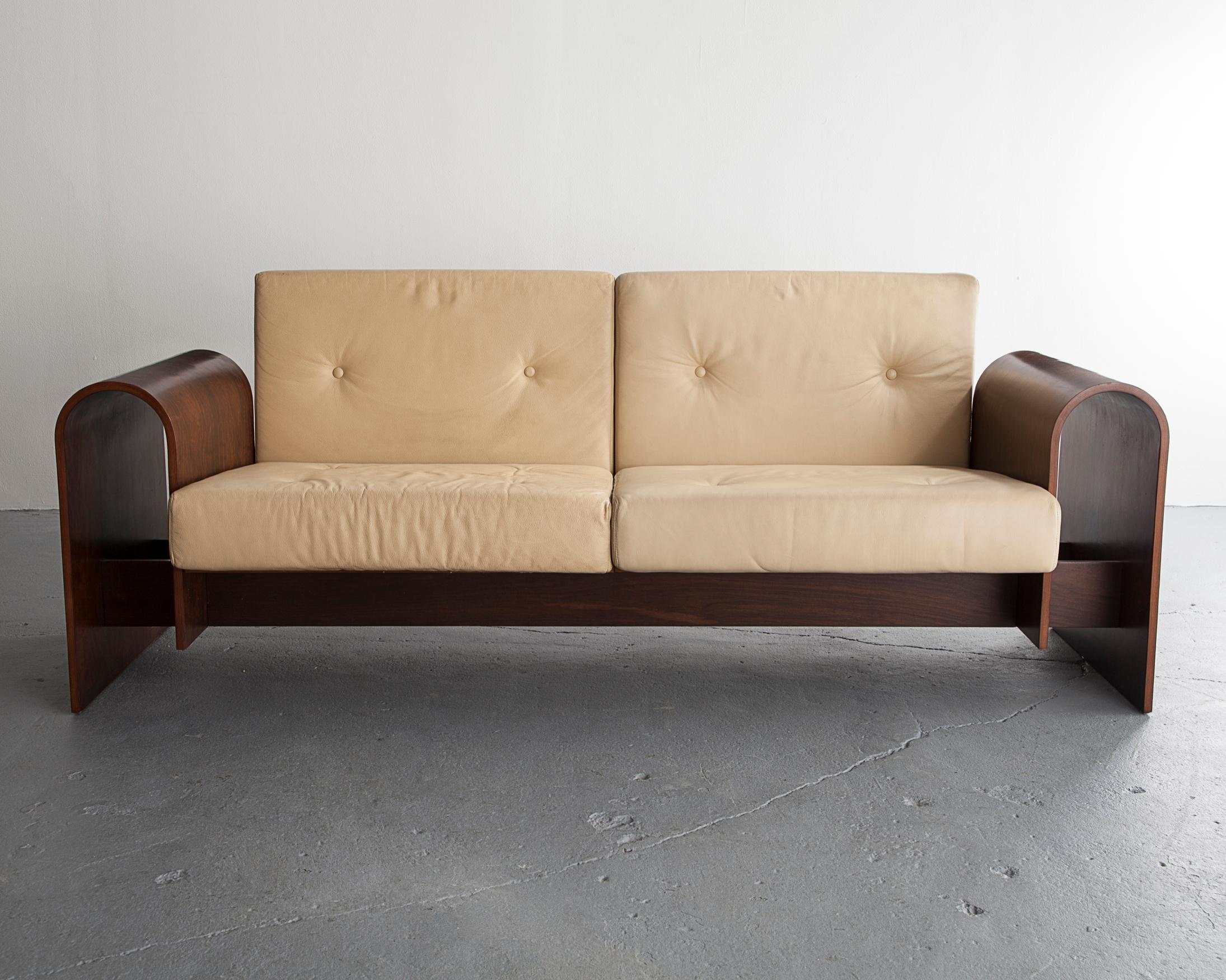 Two-seat sofa in rosewood veneer with upholstered cushions. Designed by Oscar Niemeyer for the SESC hotel, Brazil, 1990.