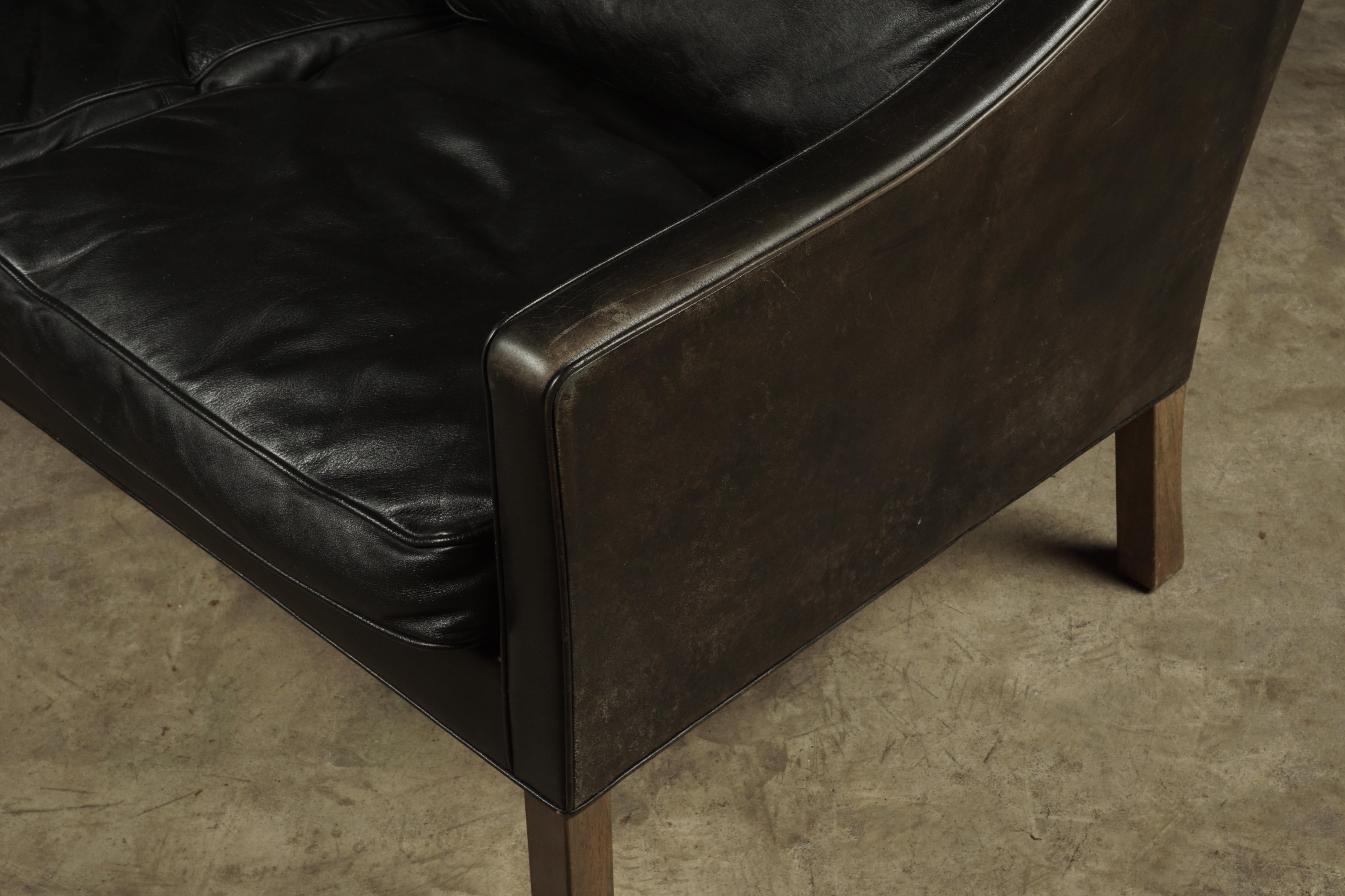 Two-seat sofa designed by Borge Mogensen, model 2209. Original black leather upholstery with nice wear and patina.