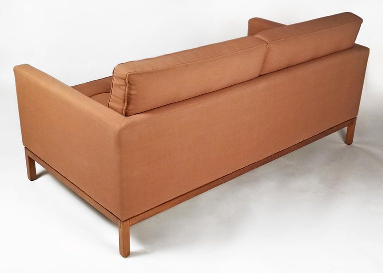 Acquired from the original owner who bought it new in 1967 from Knoll. Two-seat sofa with loose back cushions with the original upholstery. Sofa sits on walnut base and is in excellent original condition.