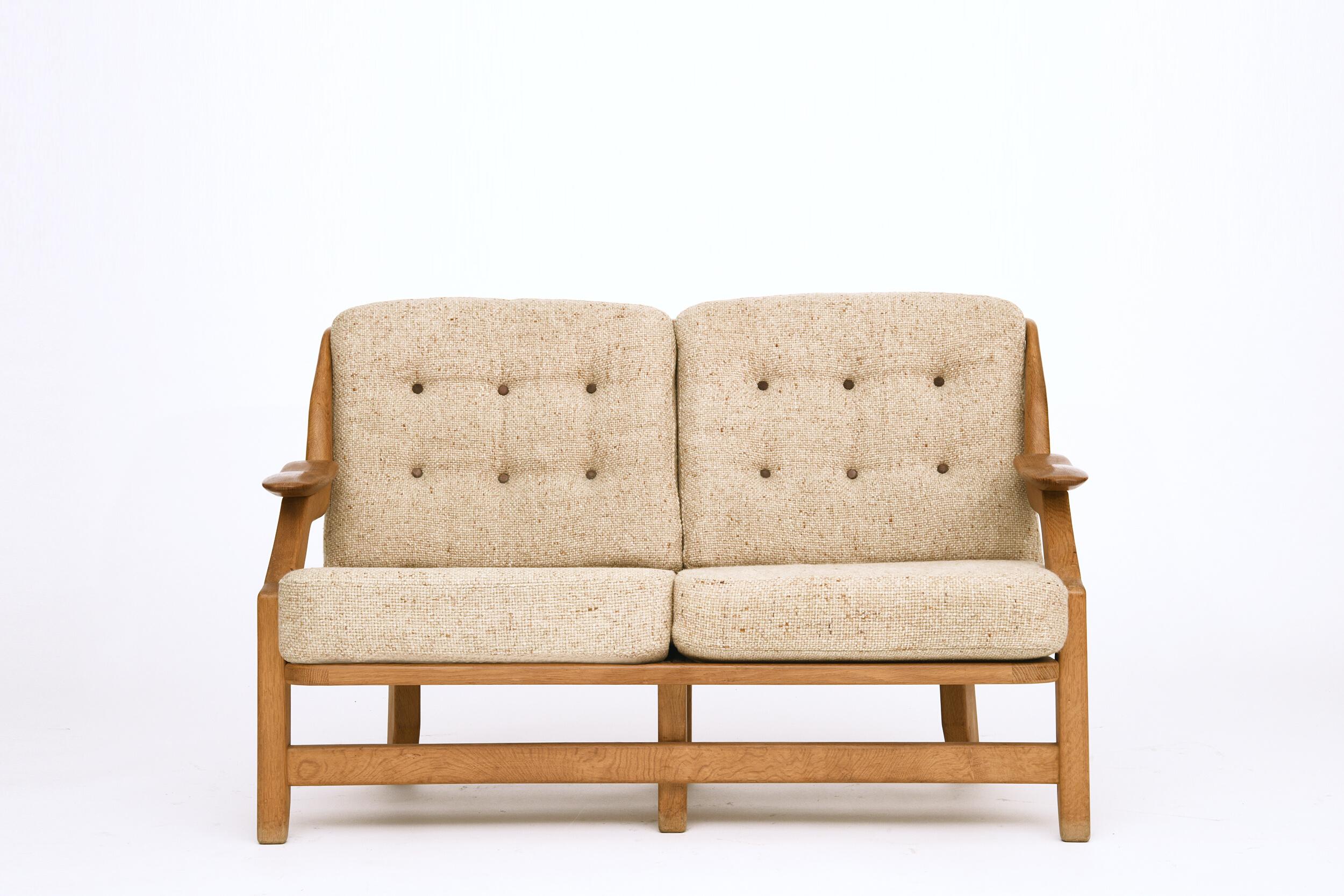This piece is a two-seat upholstered sofa by Guillerme et Chambron made circa 1950 and it is in great condition. 
Measures: Seat: 16.25 H x 48 W x 22.5 D inches 
Armrest: 22.5-23 H inches.