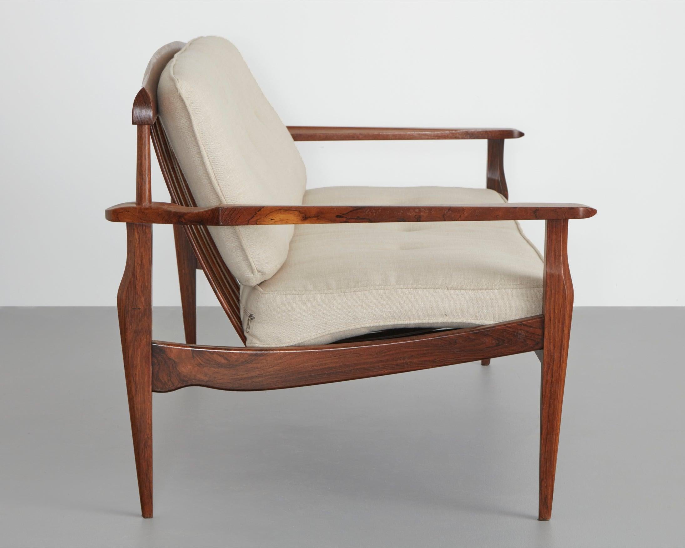 Two-seat sofa with rosewood frame and upholstered cushions. Designed by Joaquim
Tenreiro, Brazil, circa 1960s.
