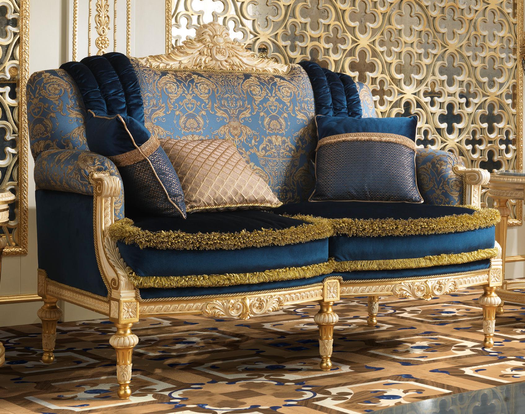 True essence of the artisanal work is shown through this luxurious classic two seater sofa. A highest quality blend of fabric choice and texture, the recreation of luxe indigo - gold tone of the velvet stripes and frill over the beautiful damask