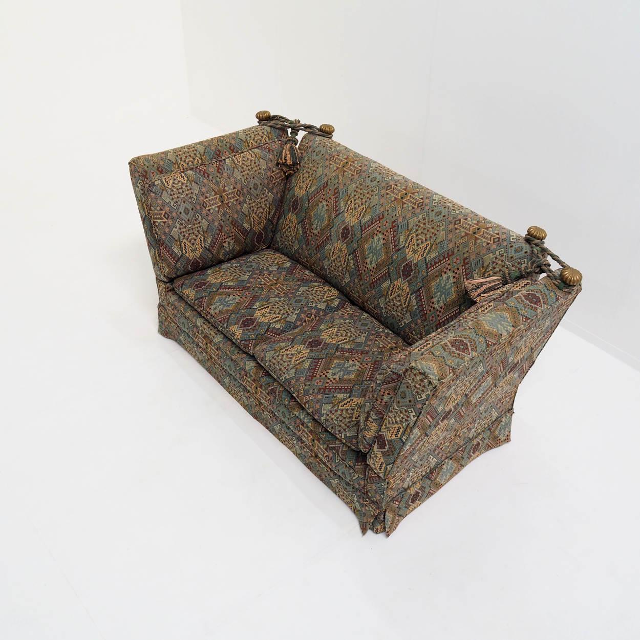 The Knole sofa, which takes its name from a village in Kent, is said to be one of the first upholstered seating furniture in England (we are talking about the 17th century). 

This sofa was specially shipped from Belgium to England by the previous