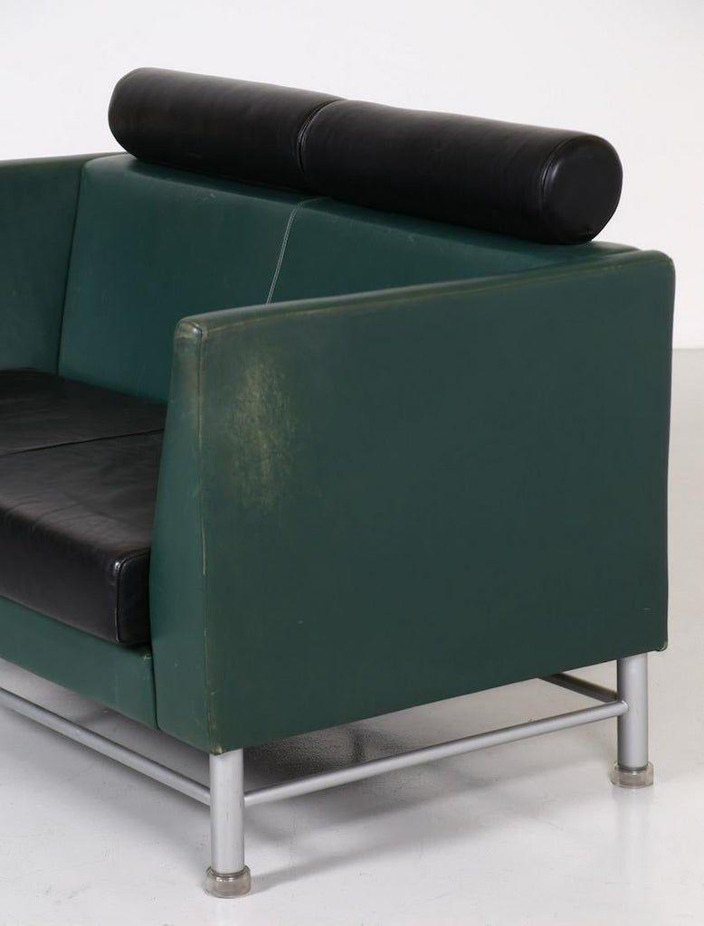 These two-seat sofa and armchair are an original pieces of design furniture designed by Ettore Sottsass for Knoll in the 1980s.

Made of metal and skai, with east side model, in black and dark green.

Two-seat dimensions: cm 134 x 85 x