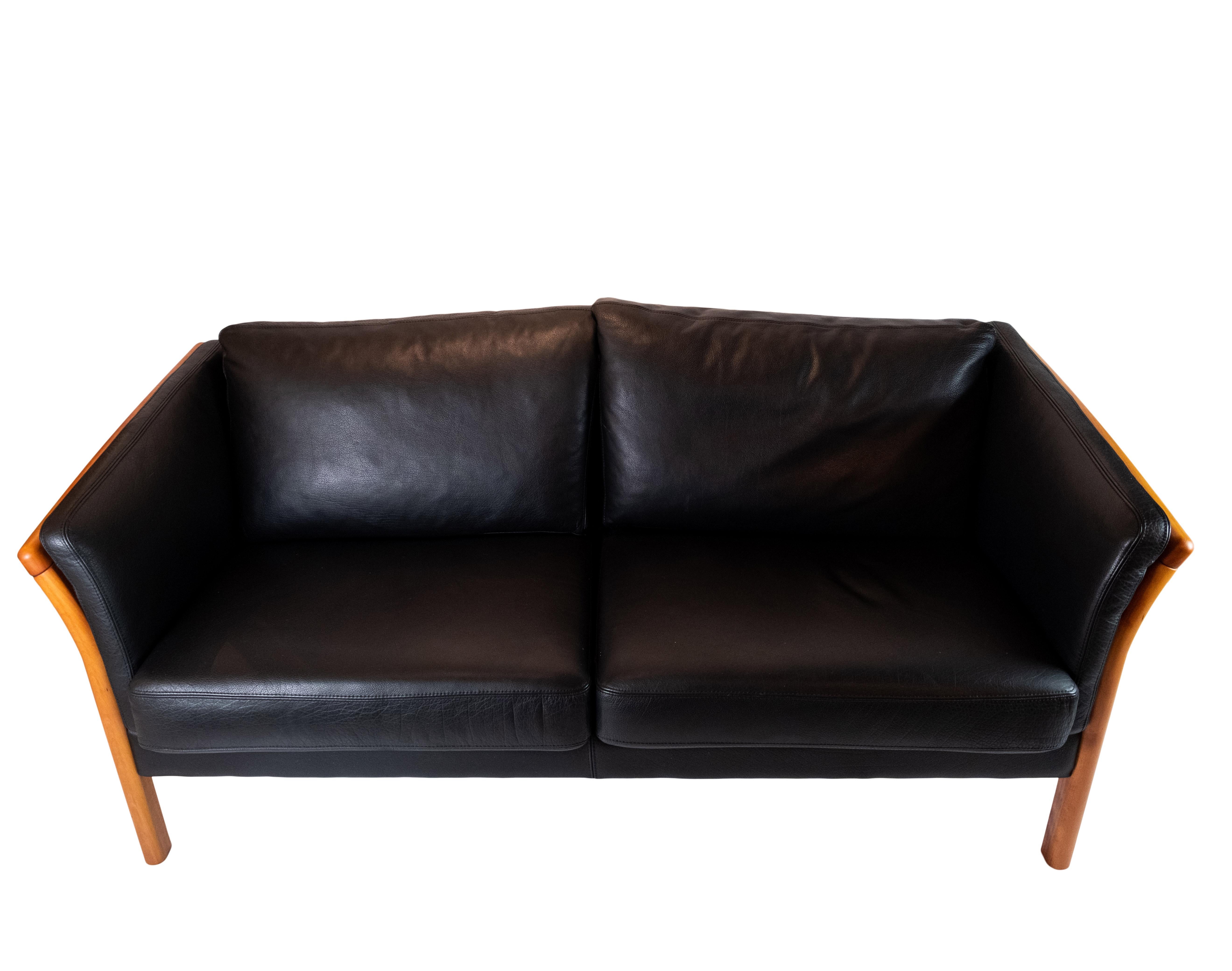 This sleek two-seater sofa, a testament to Danish design excellence, exudes sophistication and style. Upholstered in luxurious black leather, it offers both comfort and elegance in equal measure.

Crafted with precision and attention to detail, this