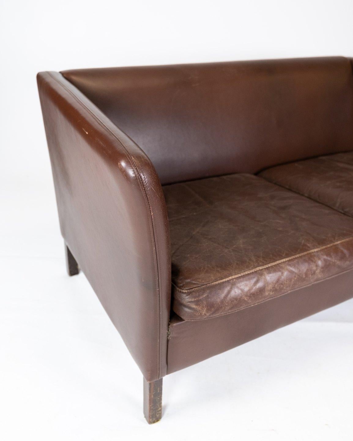 Two seater sofa upholstered with dark brown leather of Danish design manufactured by Stouby Furniture in the 1960s. The sofa is in great vintage condition.
  