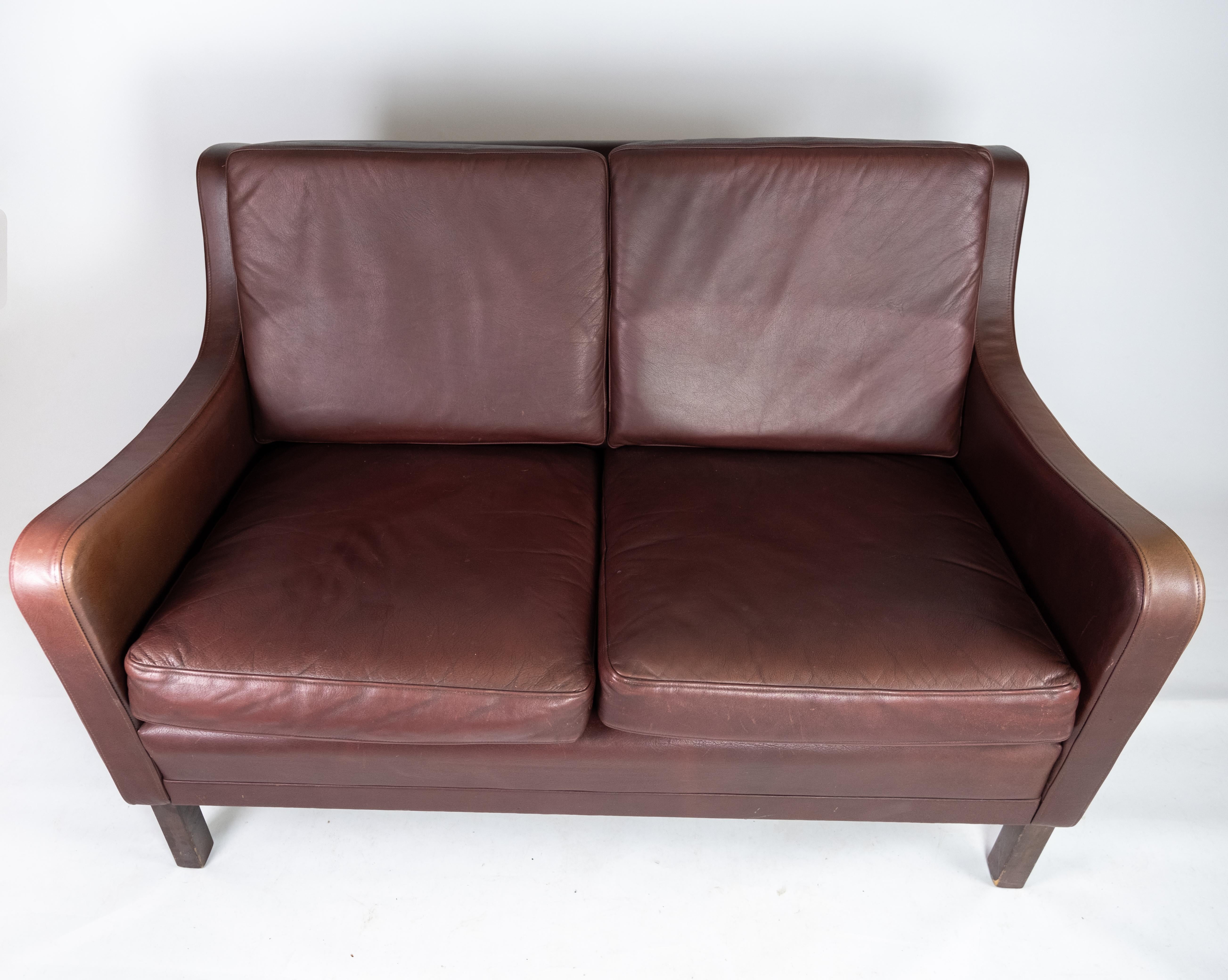 Two-seat sofa, with red brown leather by Stouby Furniture. The sofa is in great vintage condition.